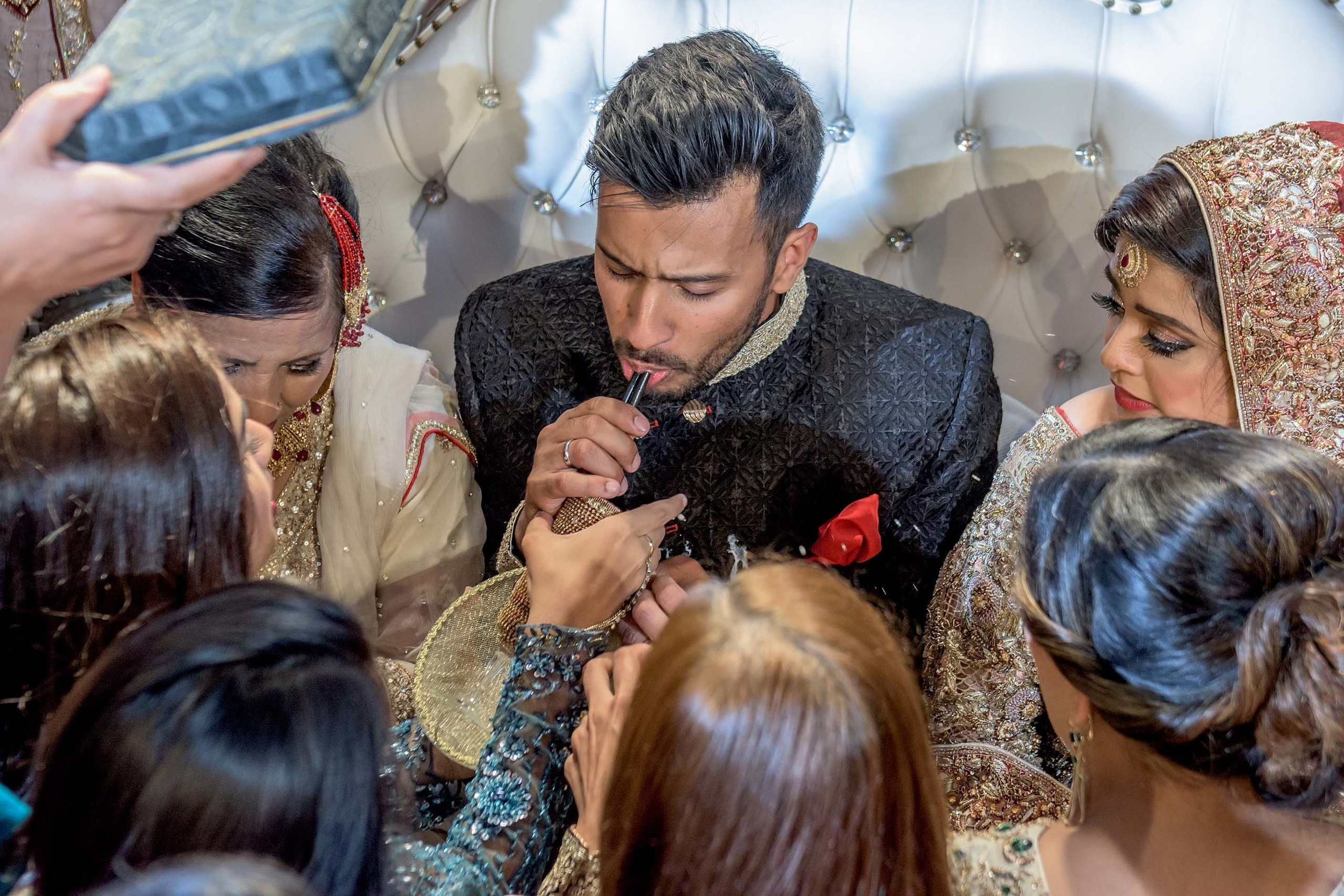 Pakistani Wedding photographer Scandic Holmenkollen Park Oslo Norway Nikon D850 Groom drinking milk