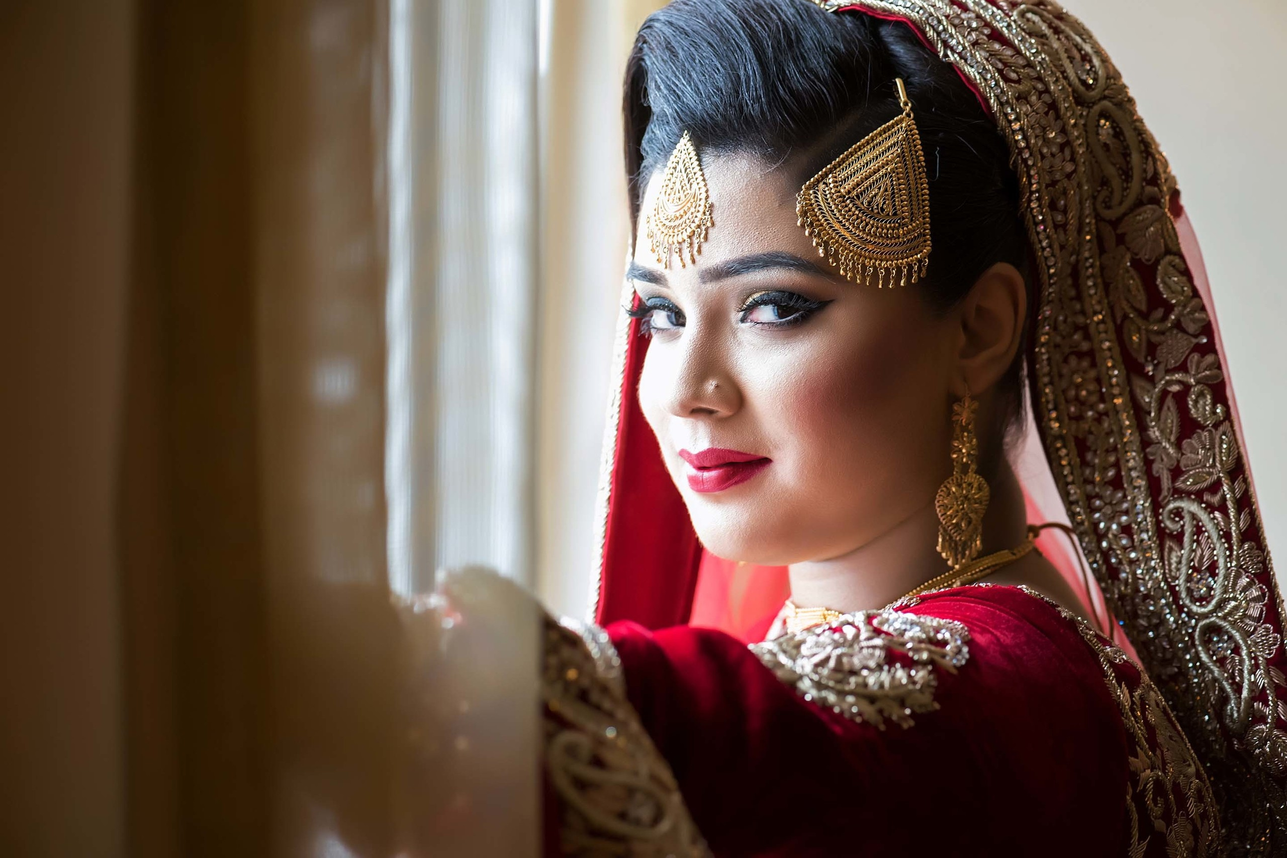 Wedding photographer Hilton London Heathrow Airport UK  Bride at the window Nikon D850