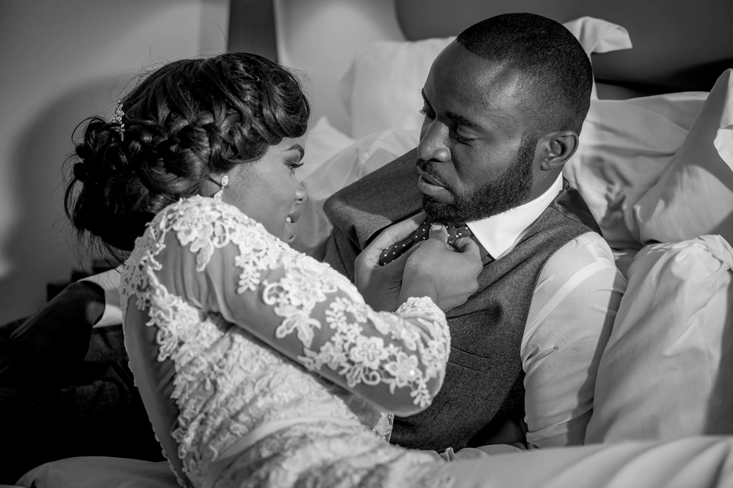 Wedding photographer The Waldorf Hilton, London UK Nikon D850  Bride arranging groom's tie