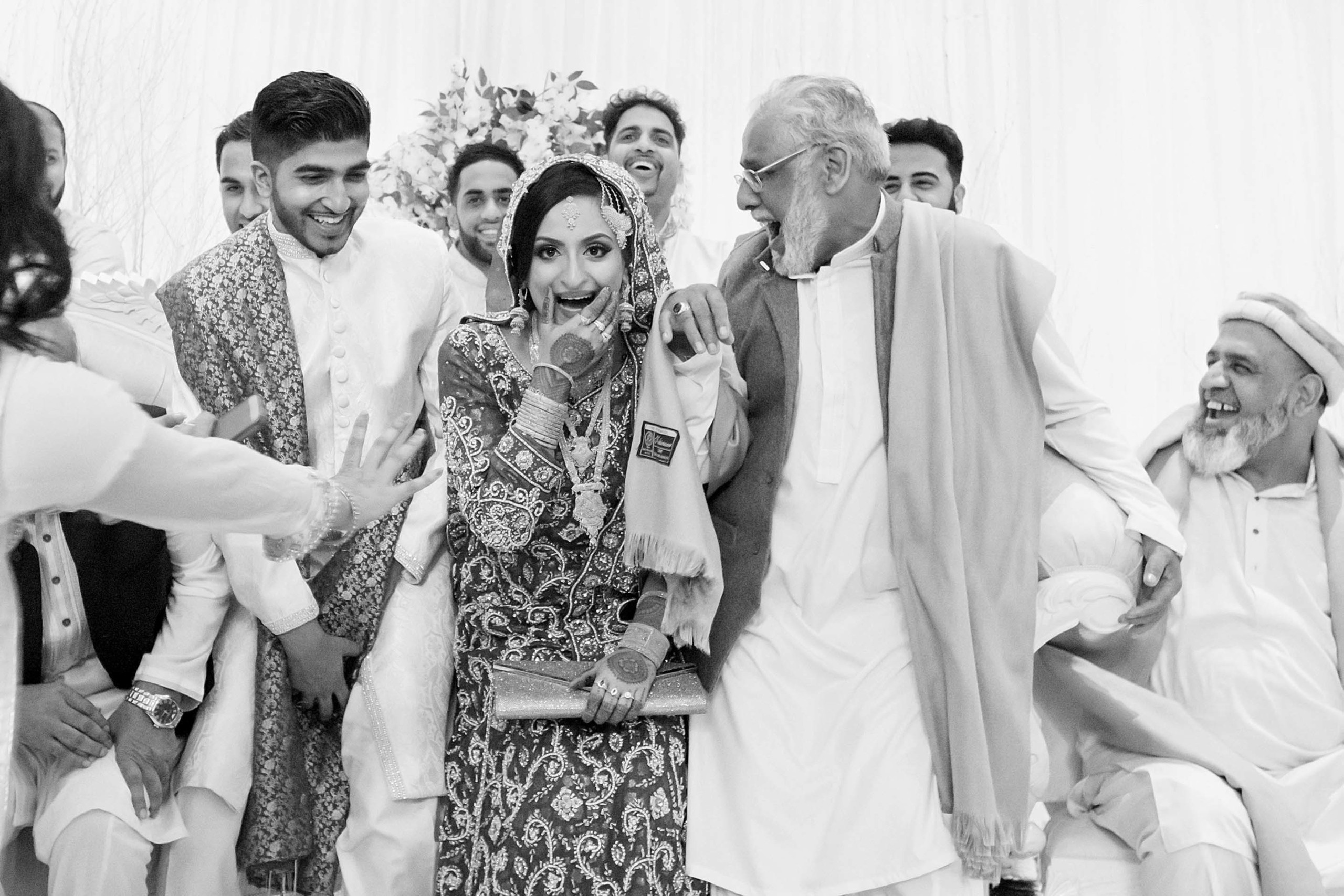 Wedding photographer Newland Manor,  Chalfont St Peter, UK  Nikon D850 everyone laughs after religious ceremony