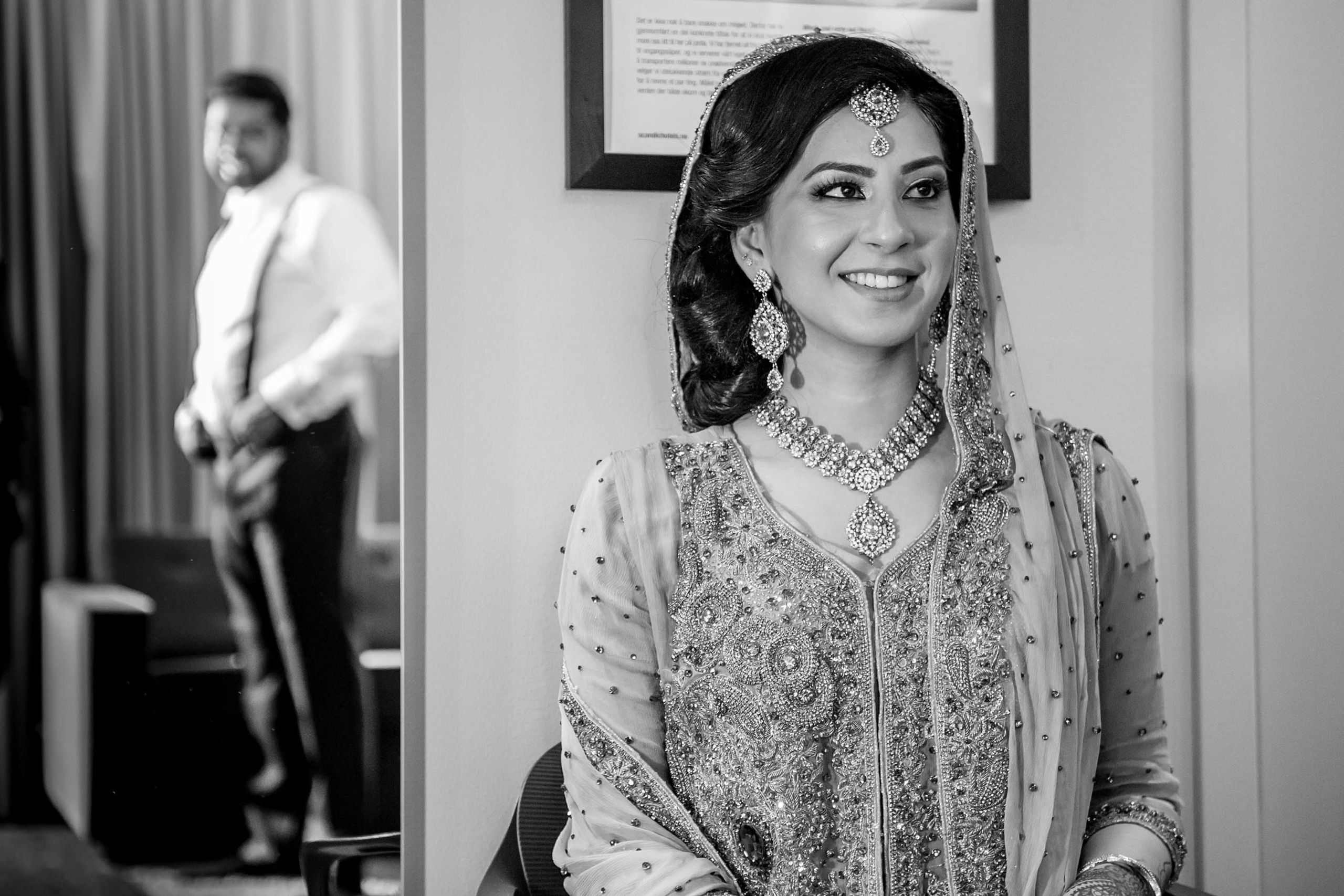 Wedding photographer Scandic Fornebu, Oslo Norway groom getting ready while bride is smiling Nikon D850