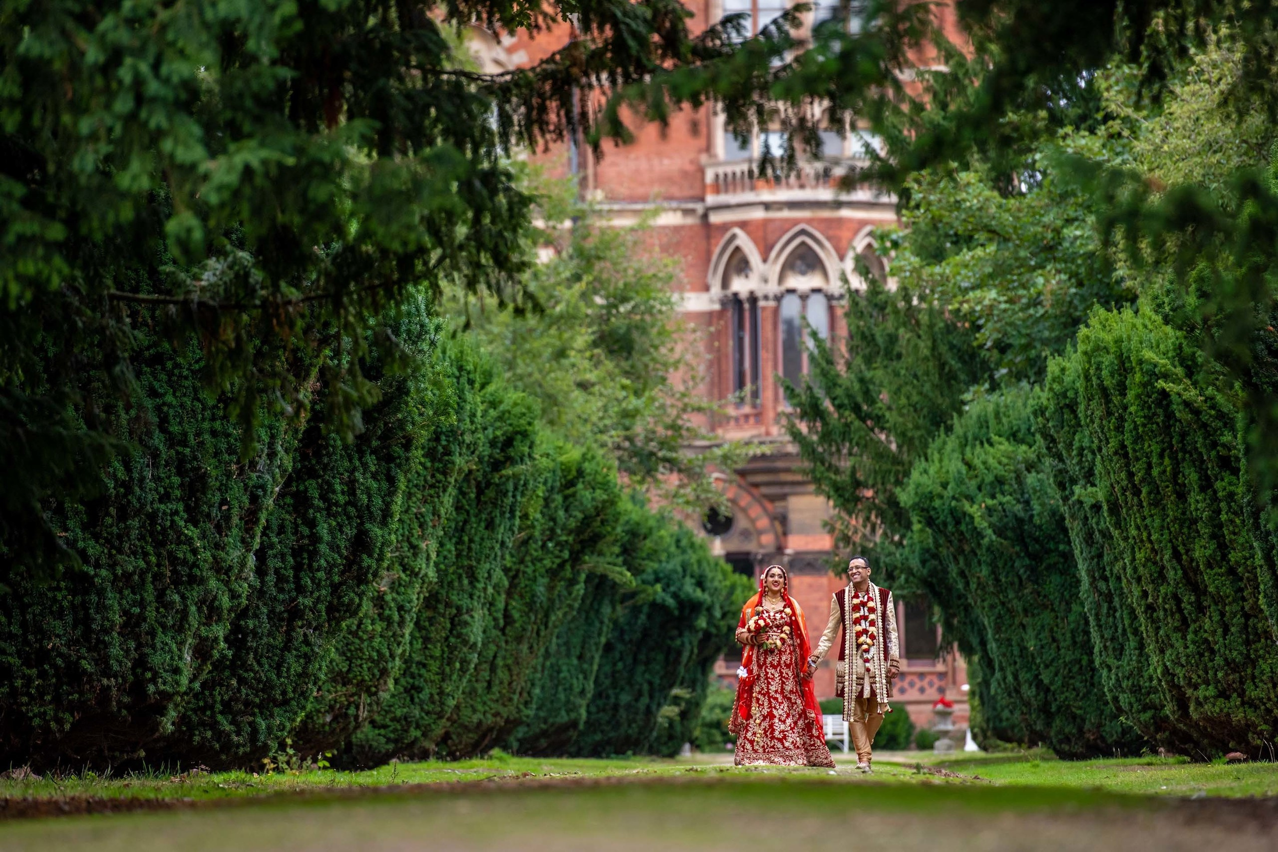 Wedding photography session Kelham Hall, Newark UK. Wedding photographer Nikon D850 couple walking between trees