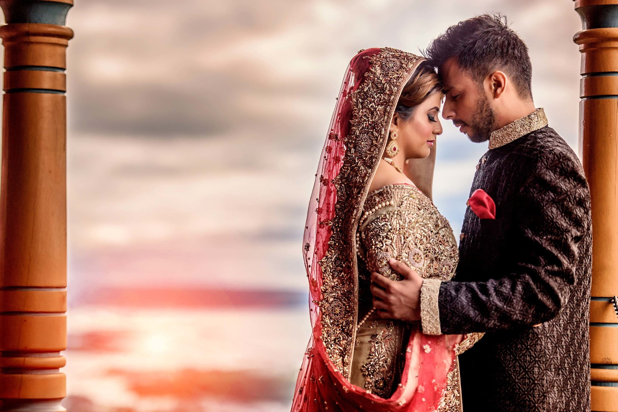 Asian couple touching foreheads and holding each other Scandic Holmenkollen Park, Norway. Wedding photographer Nikon D850