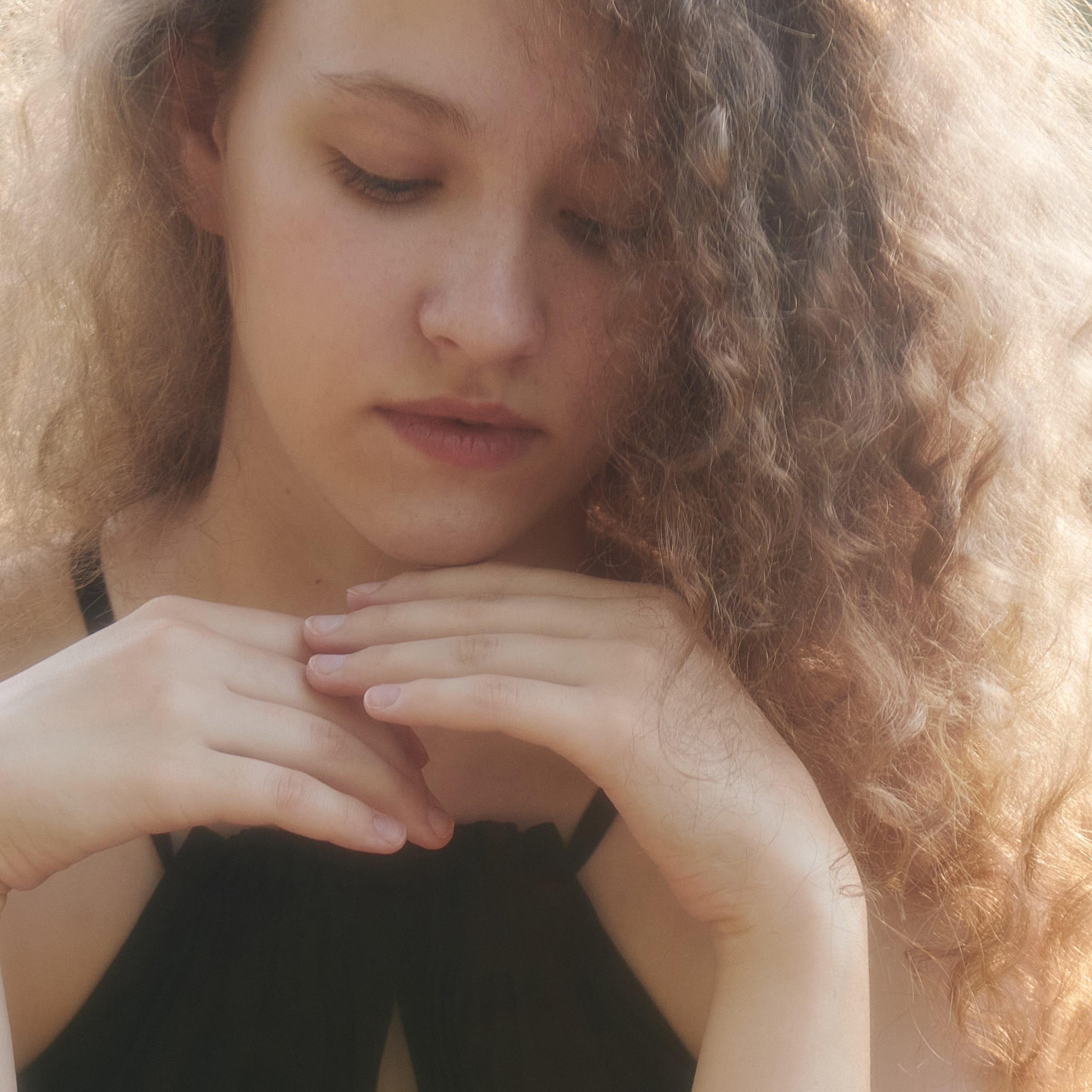 Artistic outdoor photoshoot with a model wearing dress, captured in natural light