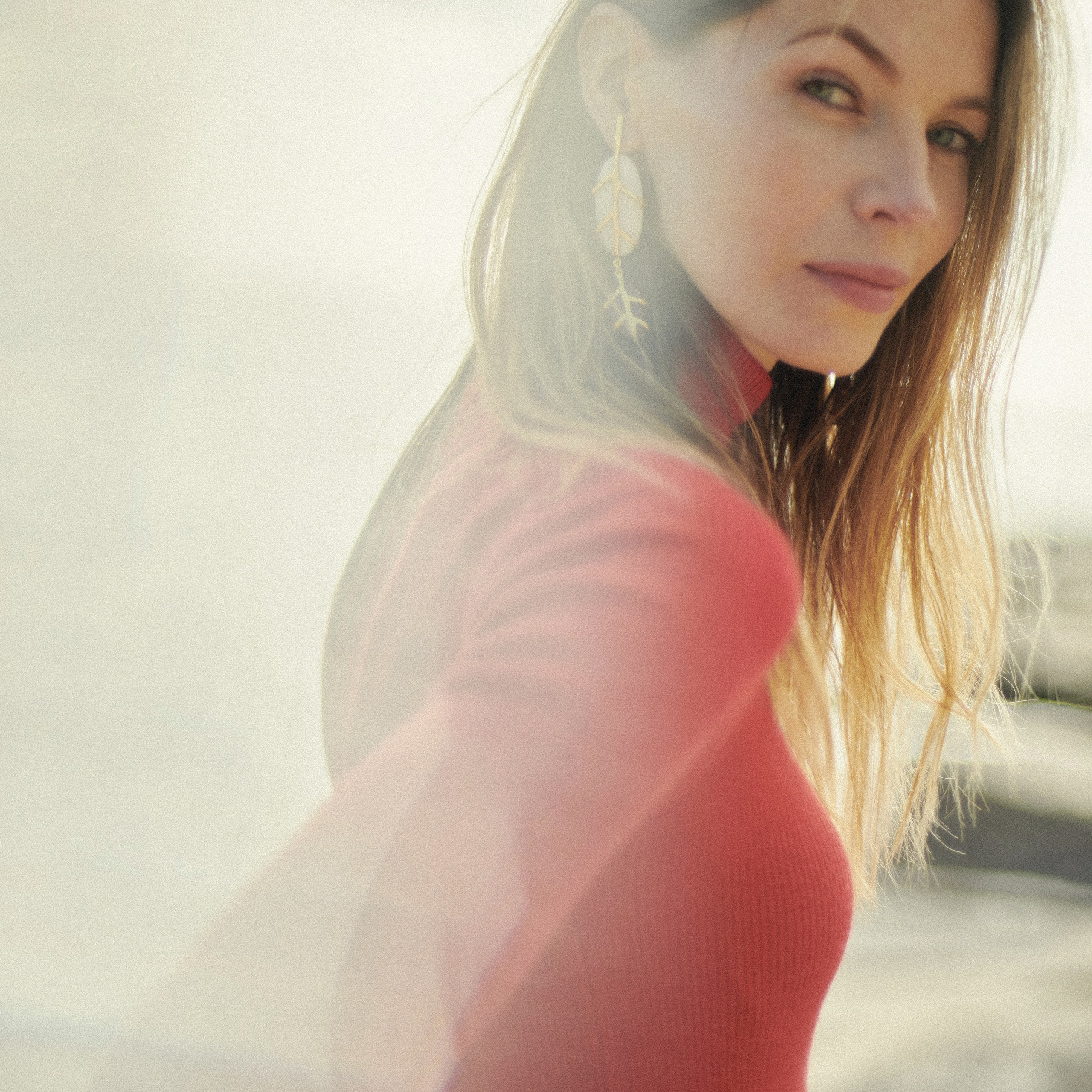 Model in red top posing for a professional outdoor photoshoot
