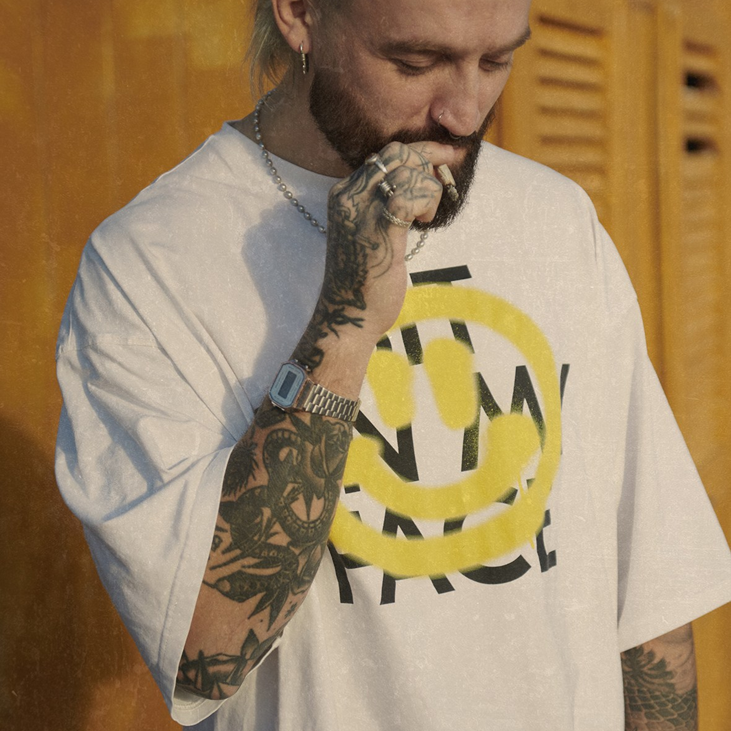 Stylish blond haired man smoking during shooting 