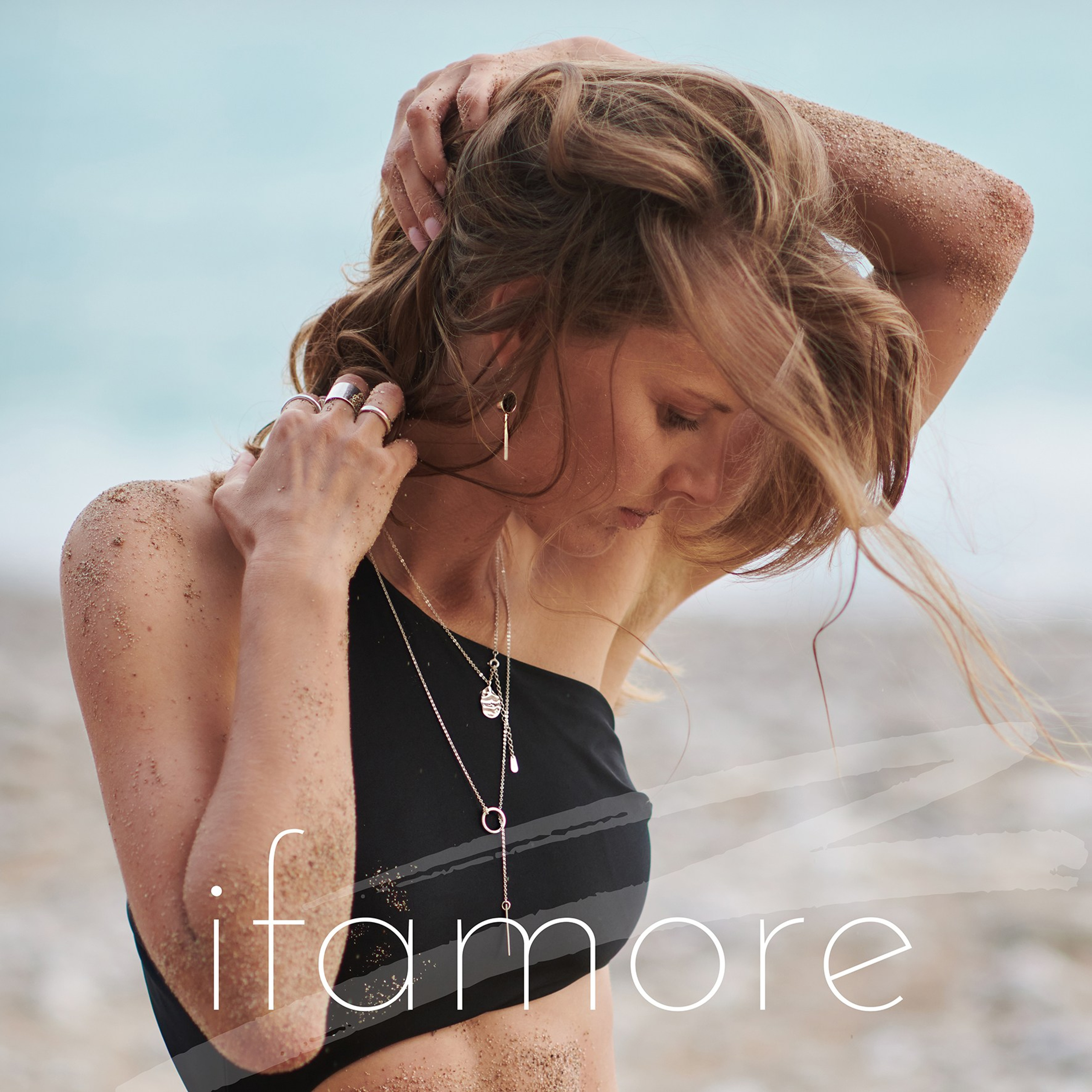 Portrait of a woman on the seaside showcasing elegant jewelry in a soft natural light 