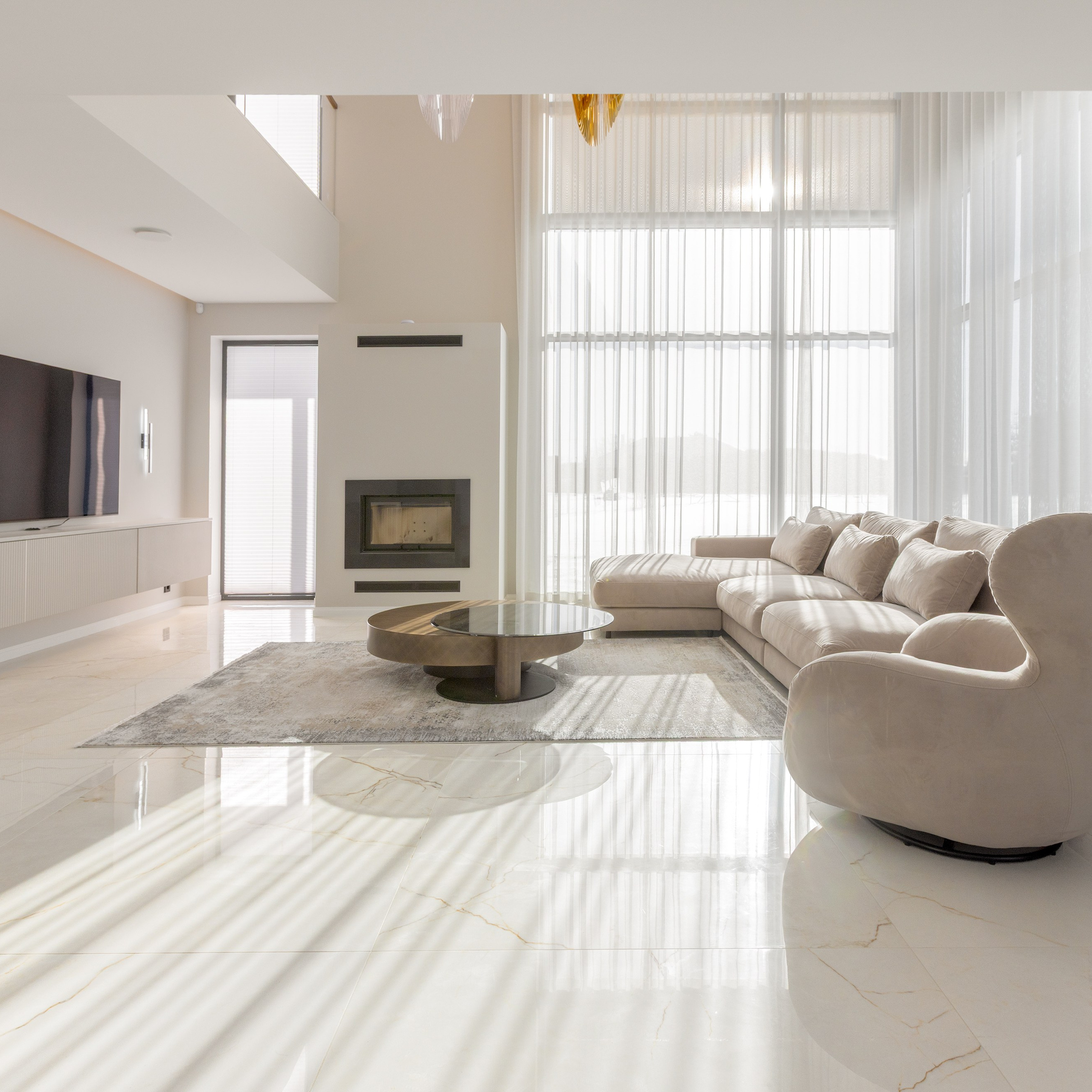 Bright living room with a sofa and large windows