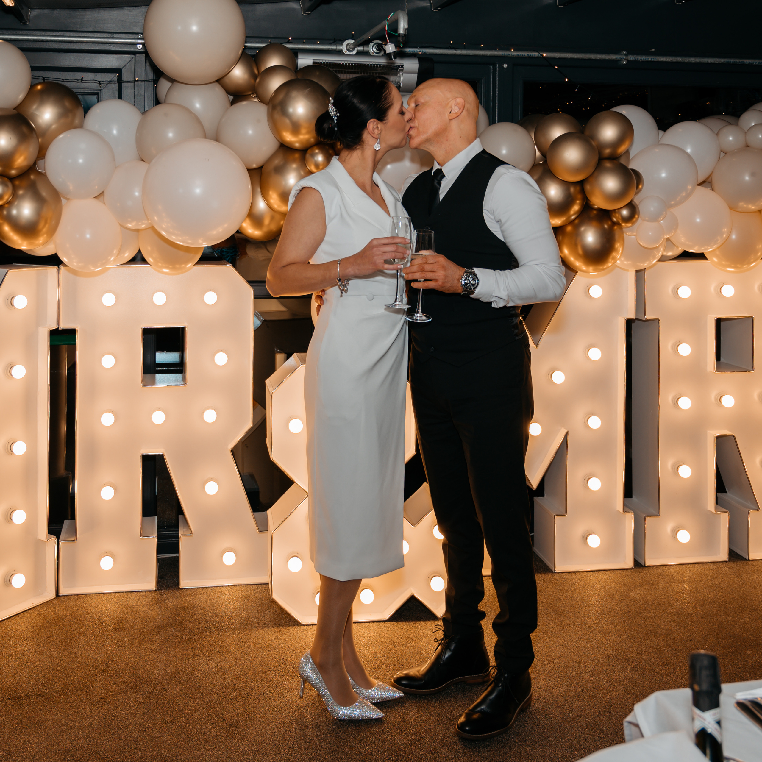 Wedding photo of bride and groom in front of MR & Mrs sign in West Yorkshire
