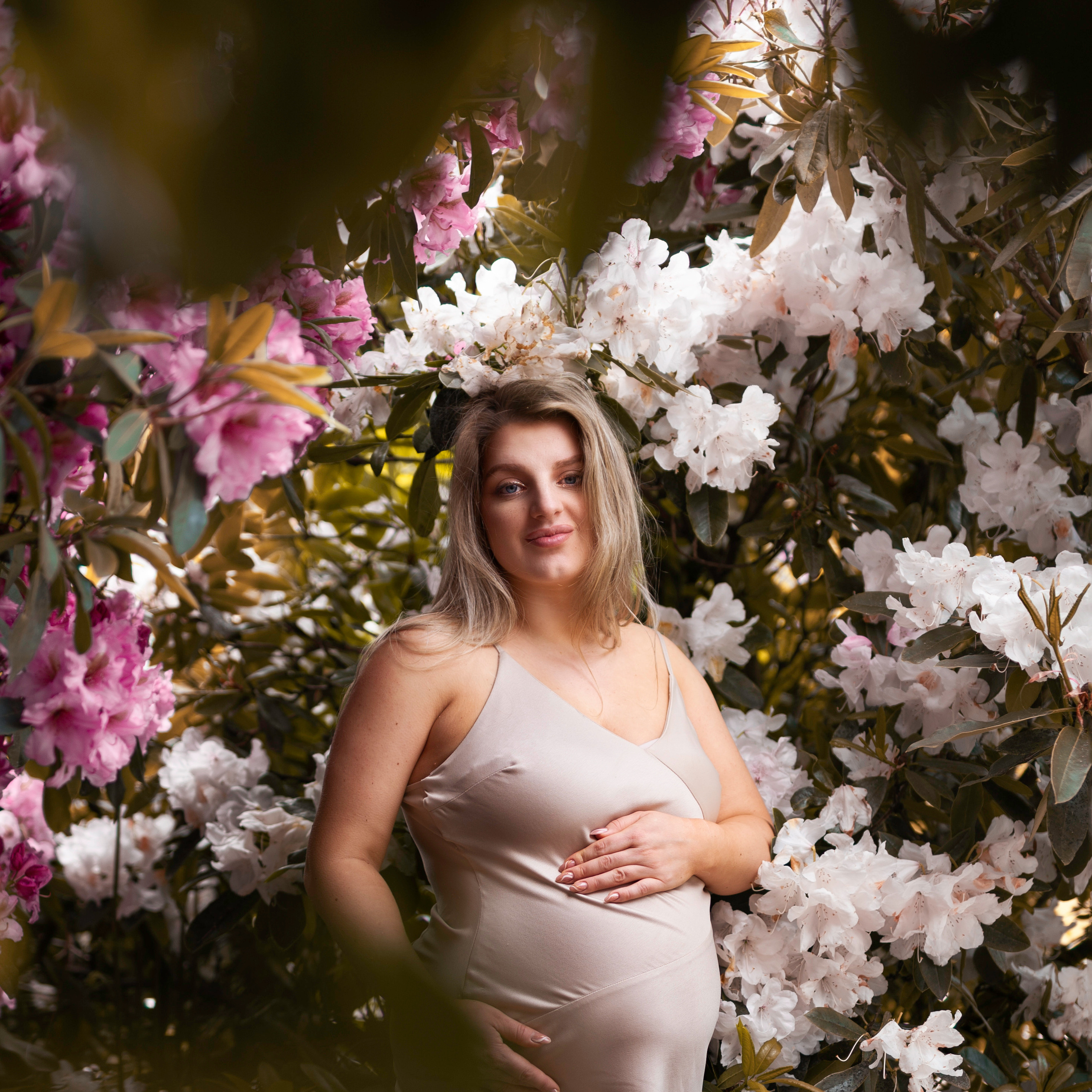 "A stunning pregnancy photoshoot among the vibrant Rhododendron blooms of Yorkshire."