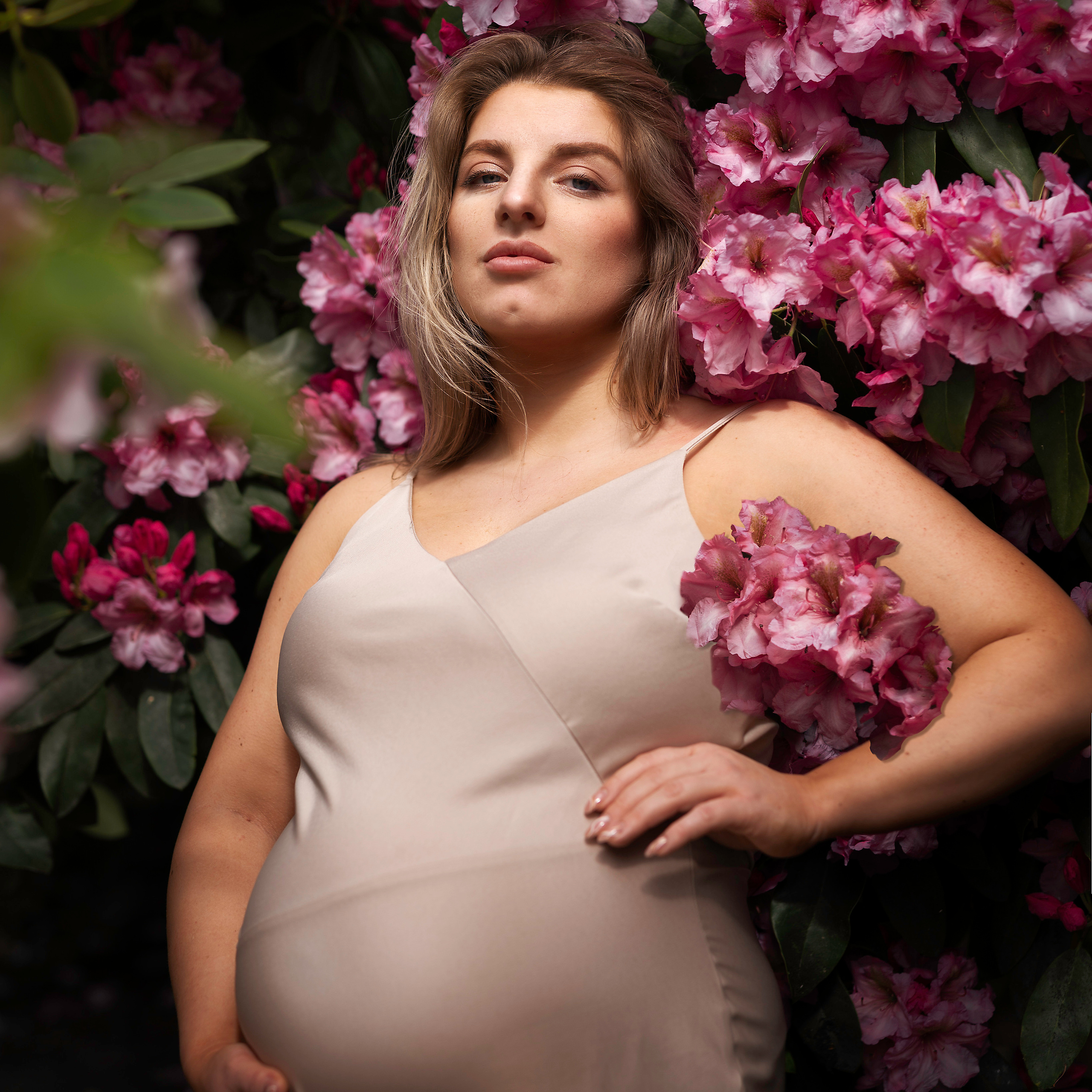 "A model poses amidst the colorful Rhododendrons at a picturesque location in Leeds."