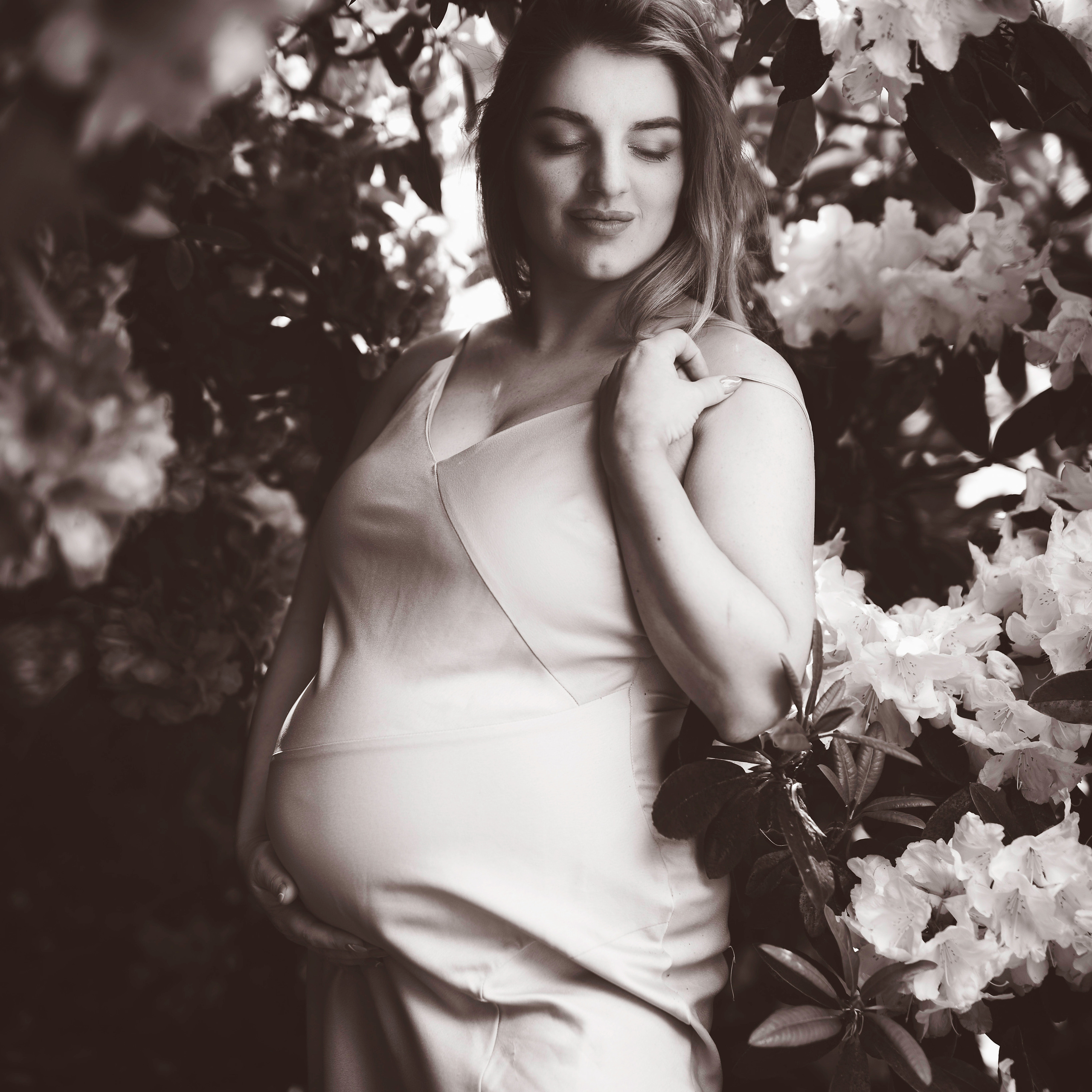 A striking photo of a model standing amidst a sea of purple rhododendrons in the gardens of Yorkshire's Ripley Castle