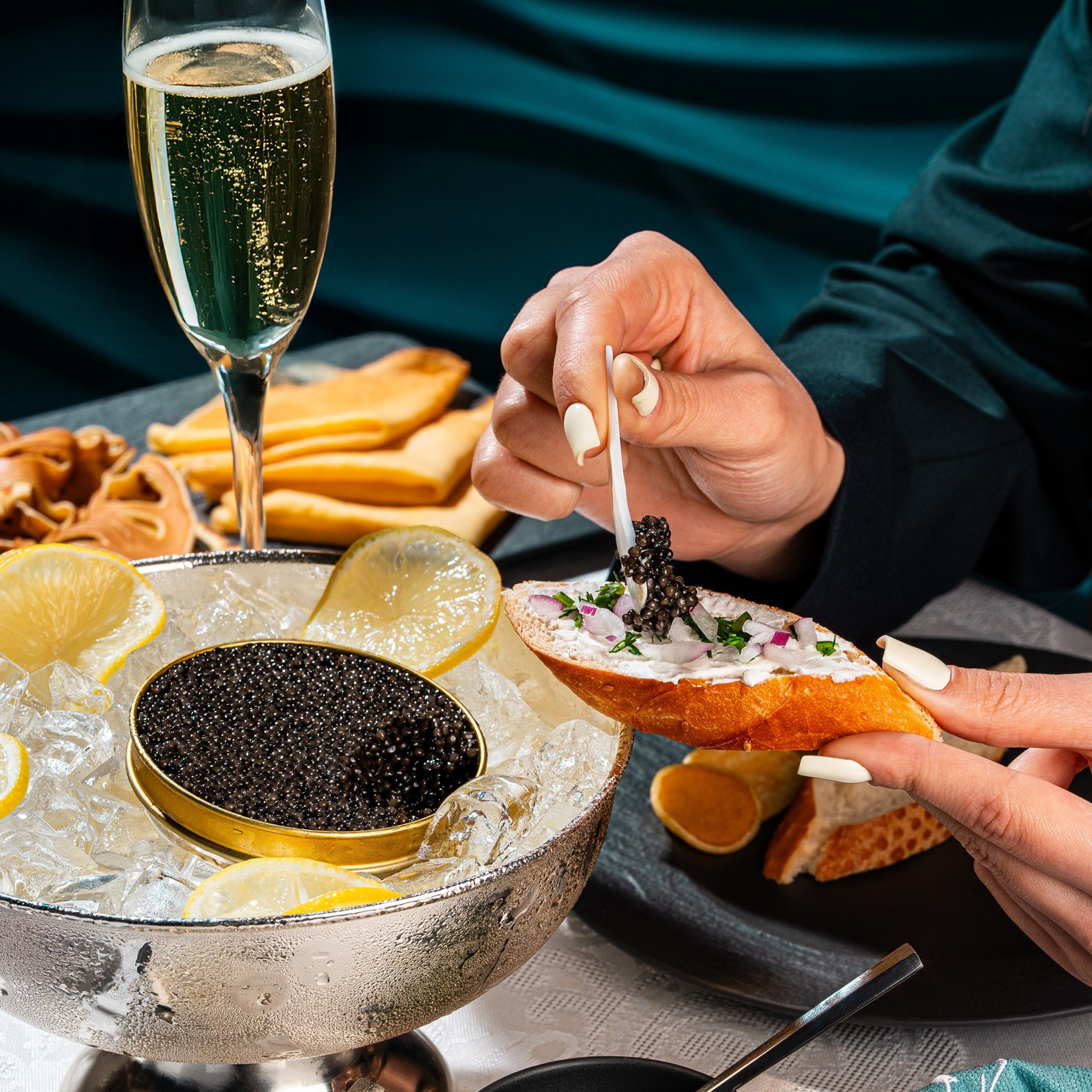 Qarışıq otlarla bəzədilmiş cəfəri, cəfəri və soğanla servis olunan kürü, limon dilimləri və şampanla lüks təqdimatda — cəfəri, smetan və baget dilimi ilə.