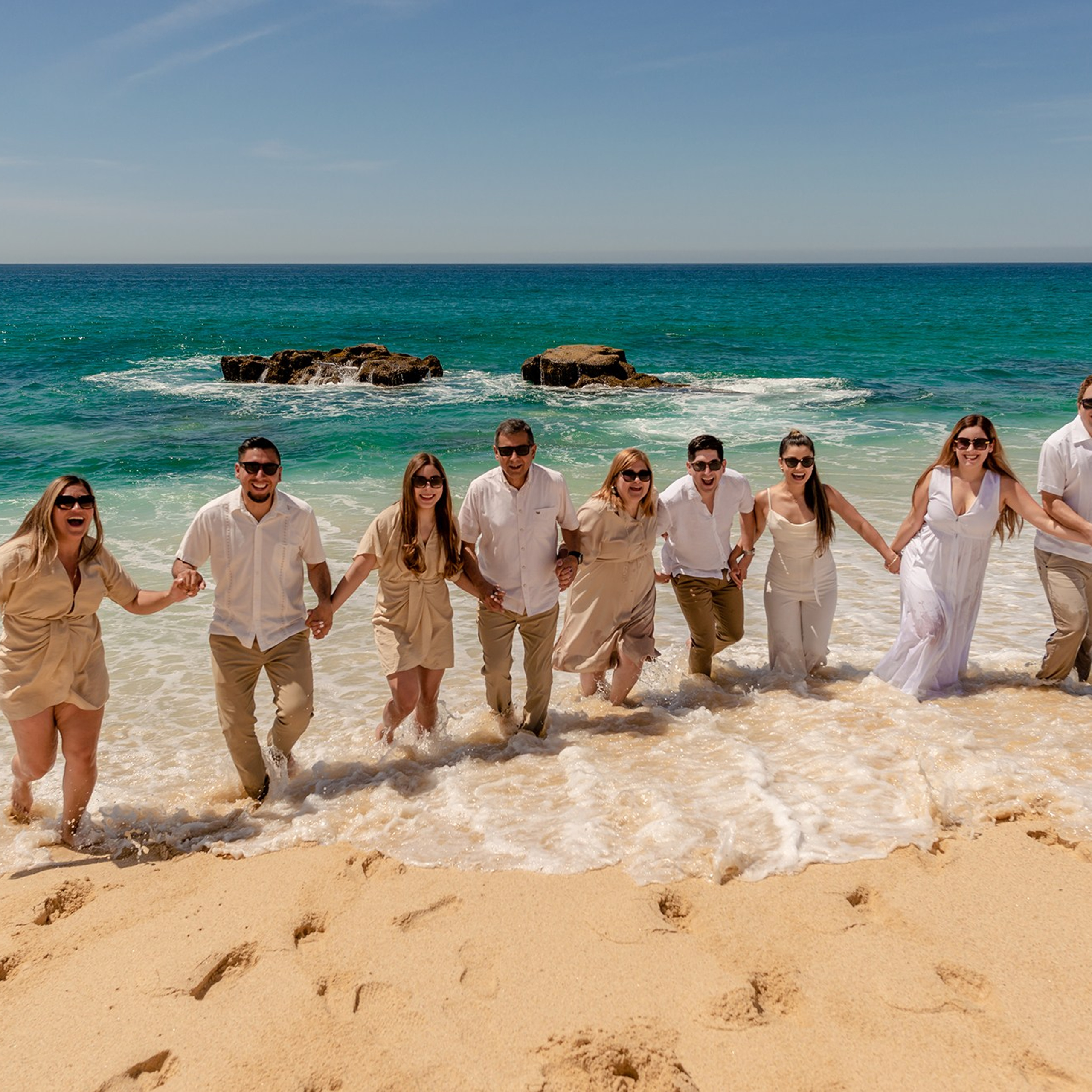 Family posing on the beach in Los Cabos.