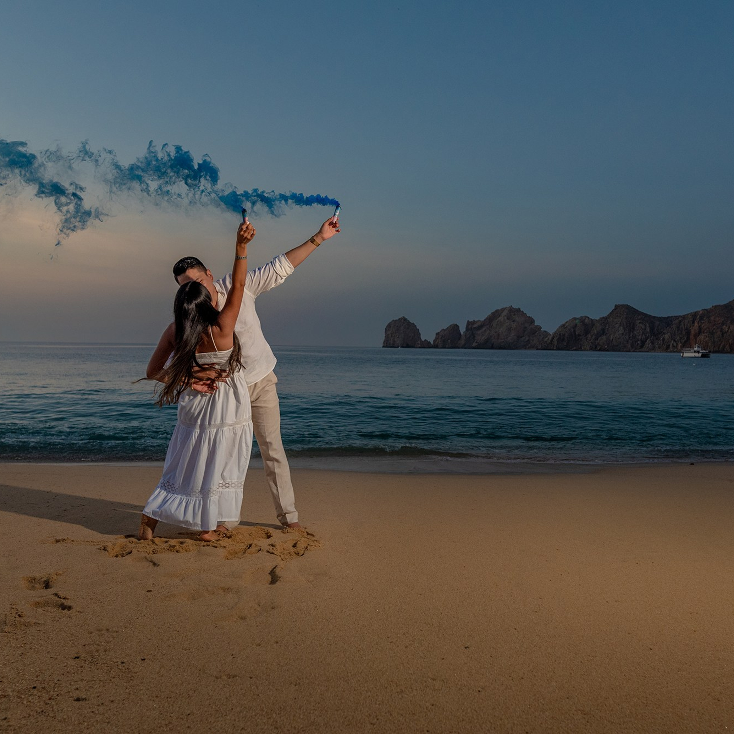 Maternity photoshoot in Los Cabos – pregnant mother on the beach embracing her baby bump, capturing the love and magic of new life by the ocean