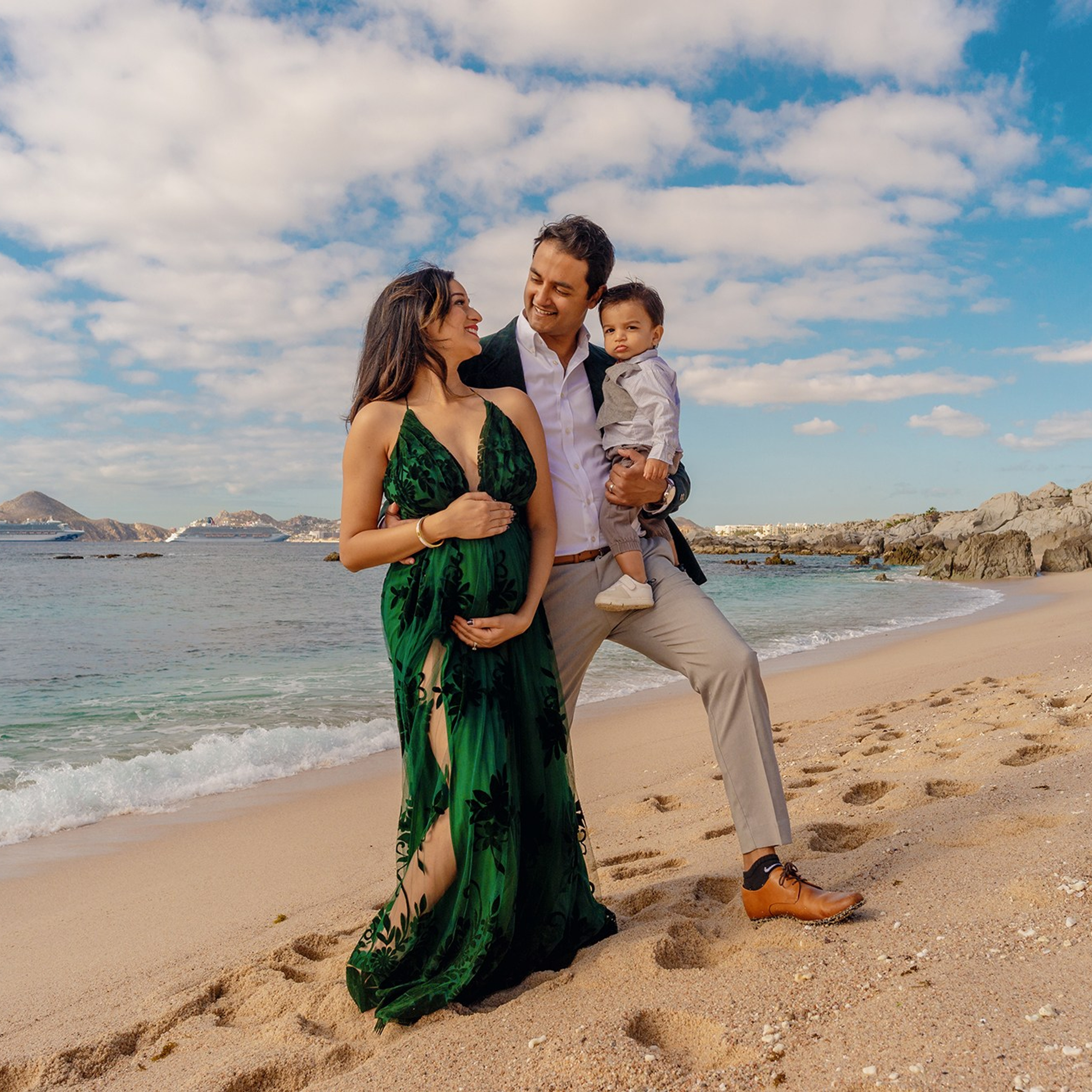 Los Cabos maternity photographer – elegant portrait of expecting mother in a dress flowing in the wind, highlighting the love, strength, and beauty of pregnancy by the se