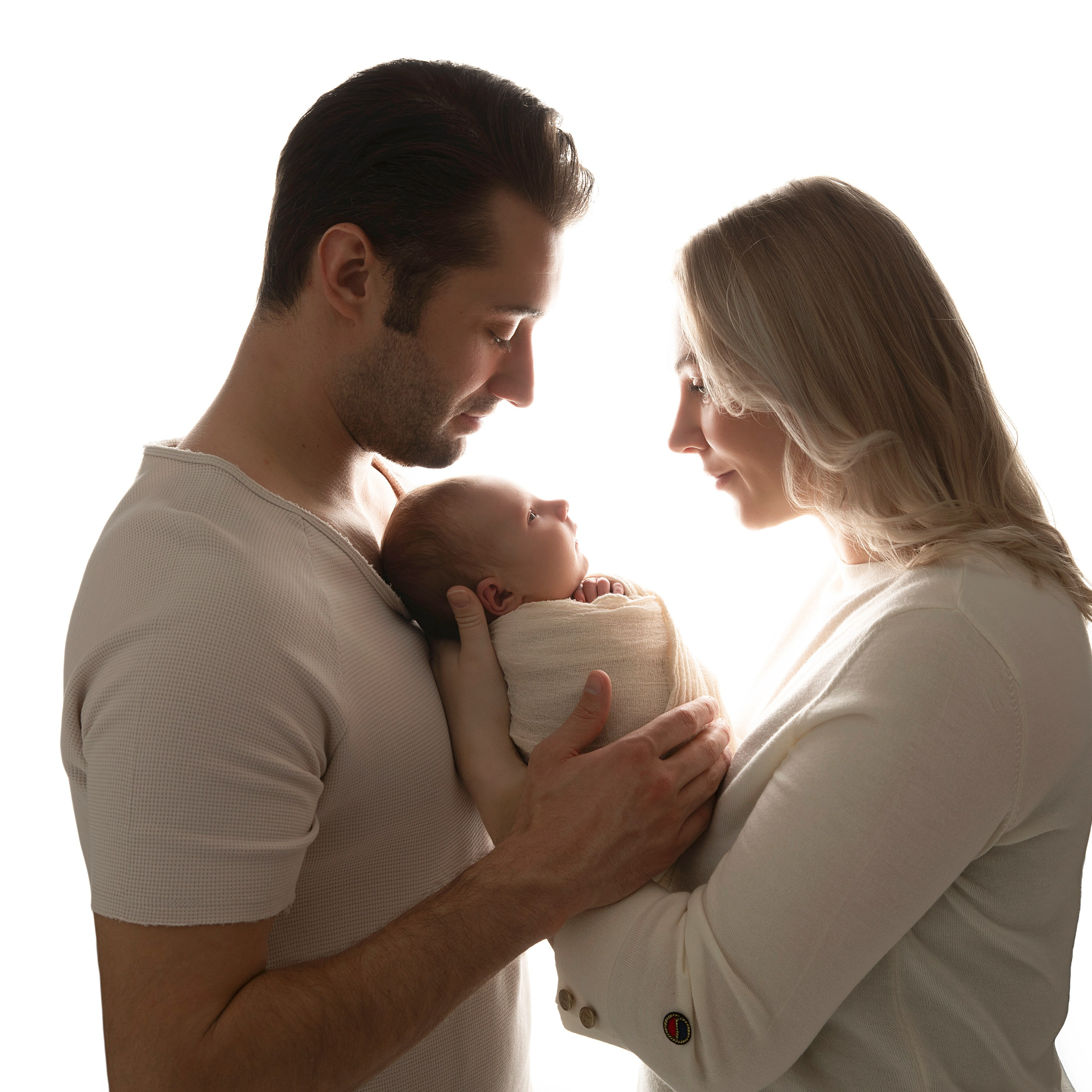 Söta ögonblick mellan en nyfödd baby och den stolta stora syskonet som sitter tillsammans i en mjuk filt. Bilden fångar den speciella bindningen mellan det nyfödda barnet och det äldre syskonet."