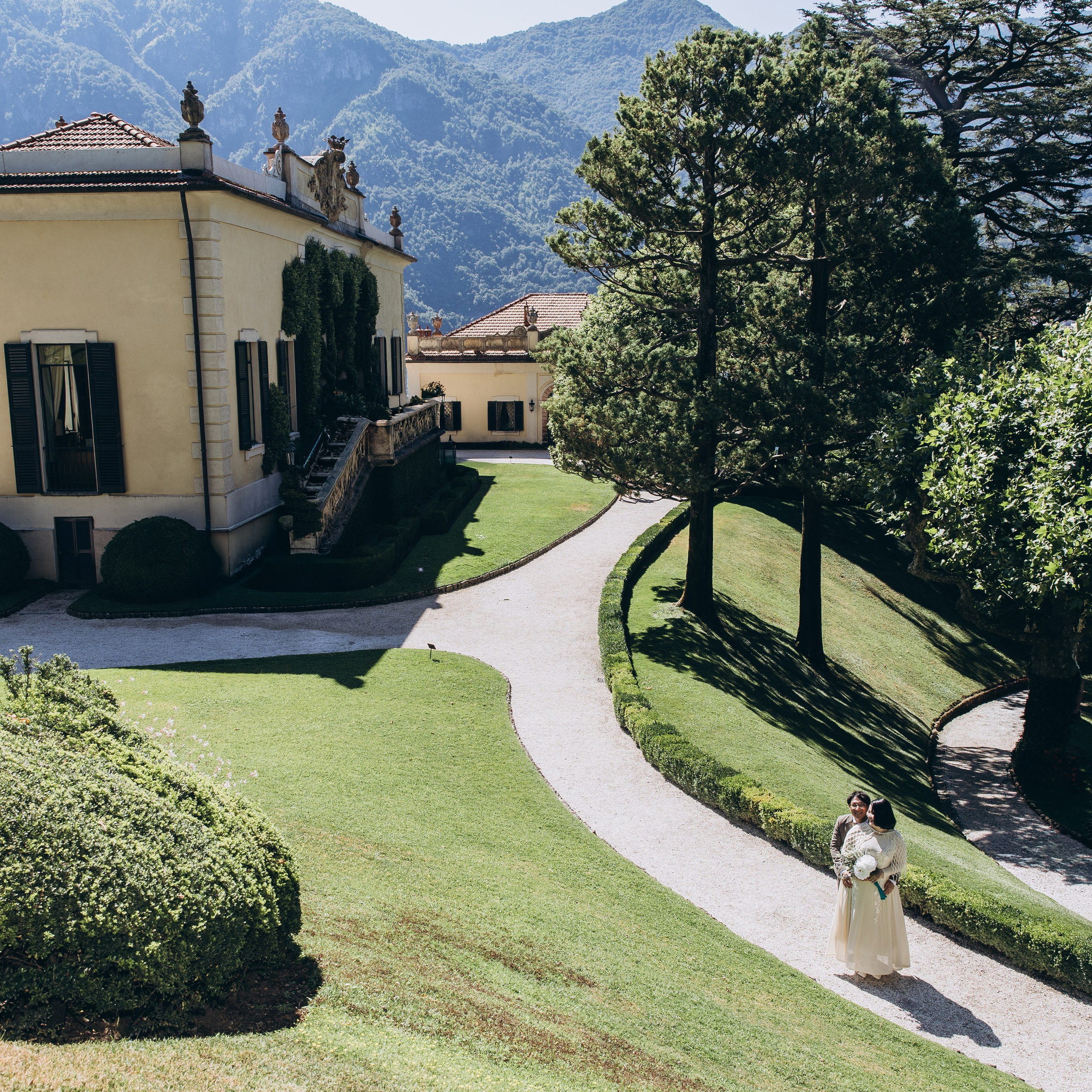 Historic Italian villa with a landscaped garden and green lawn overlooking Lake Como