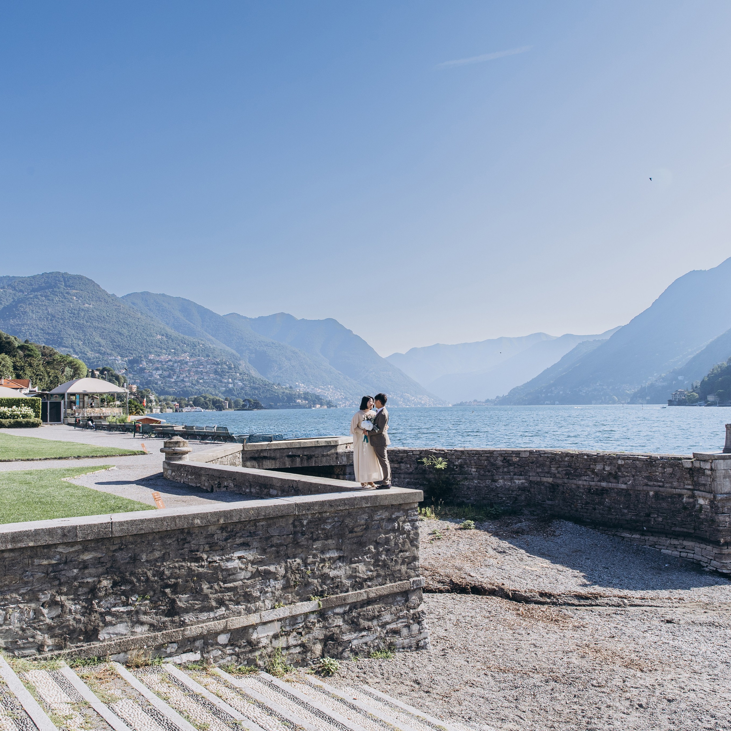 Lake Como wedding photography featuring a couple on a stone terrace overlooking the lake