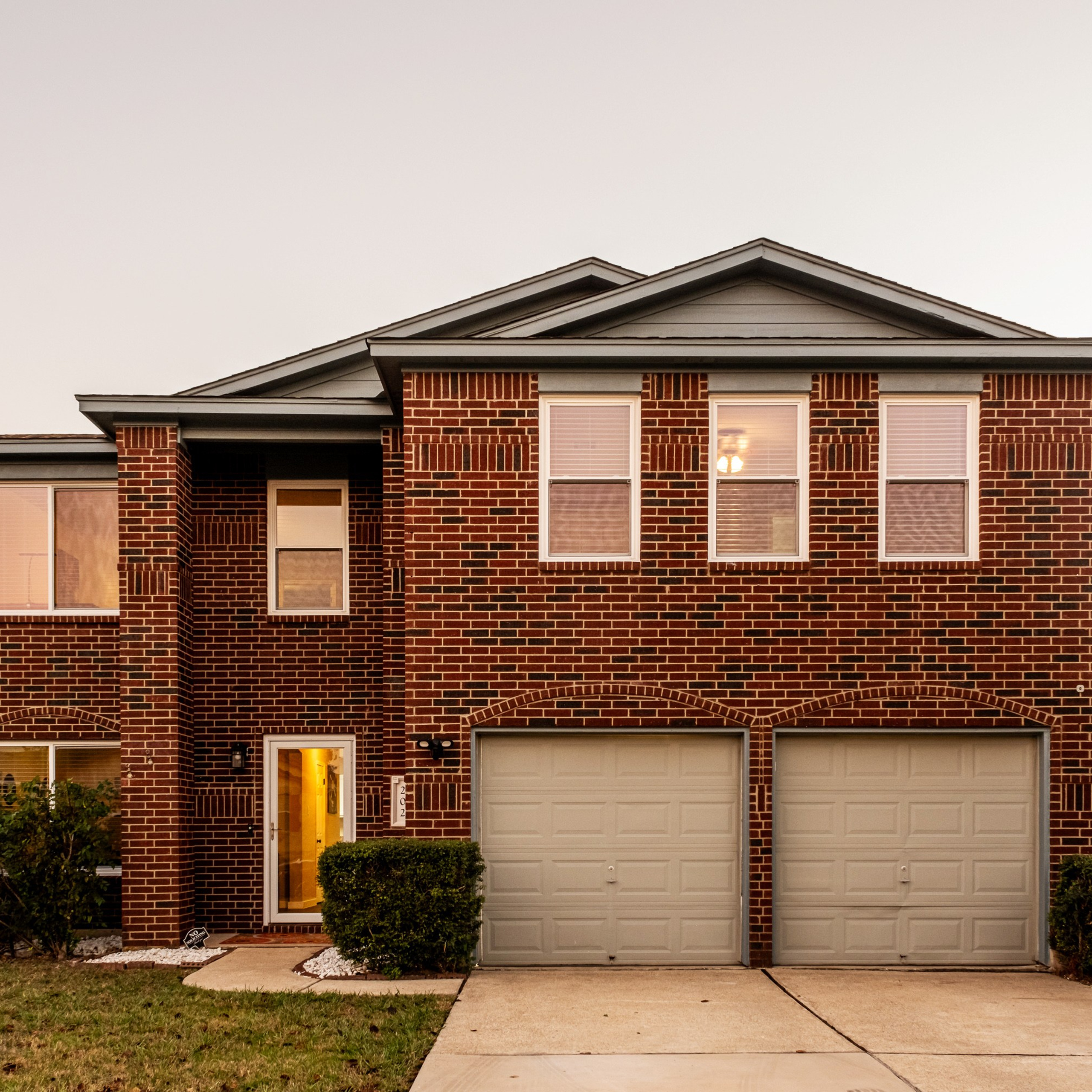 Modern house exterior at twilight with illuminated windows Austin real estate photography