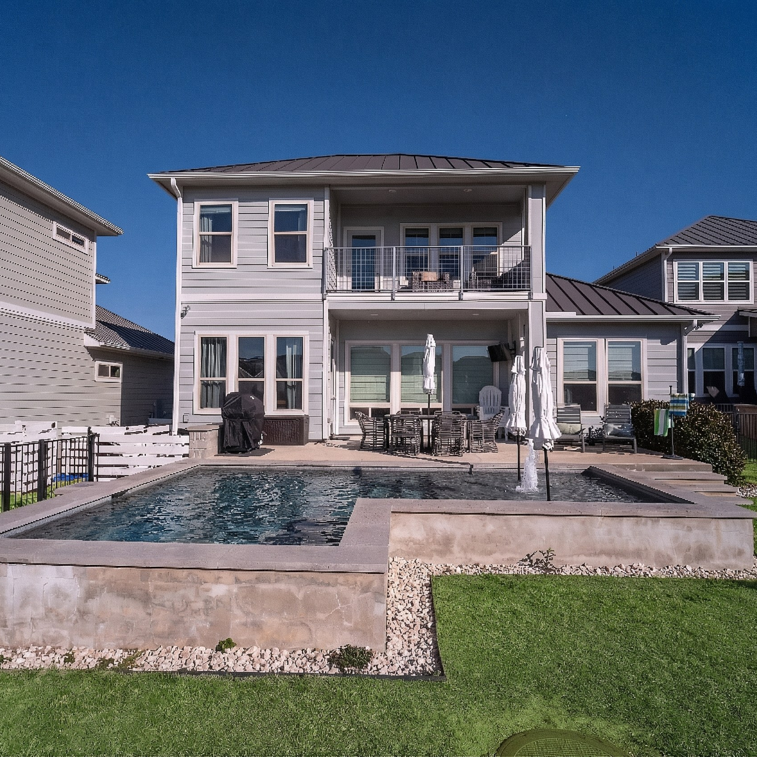 Modern two-story house with backyard pool photographed by Austin real estate photographer