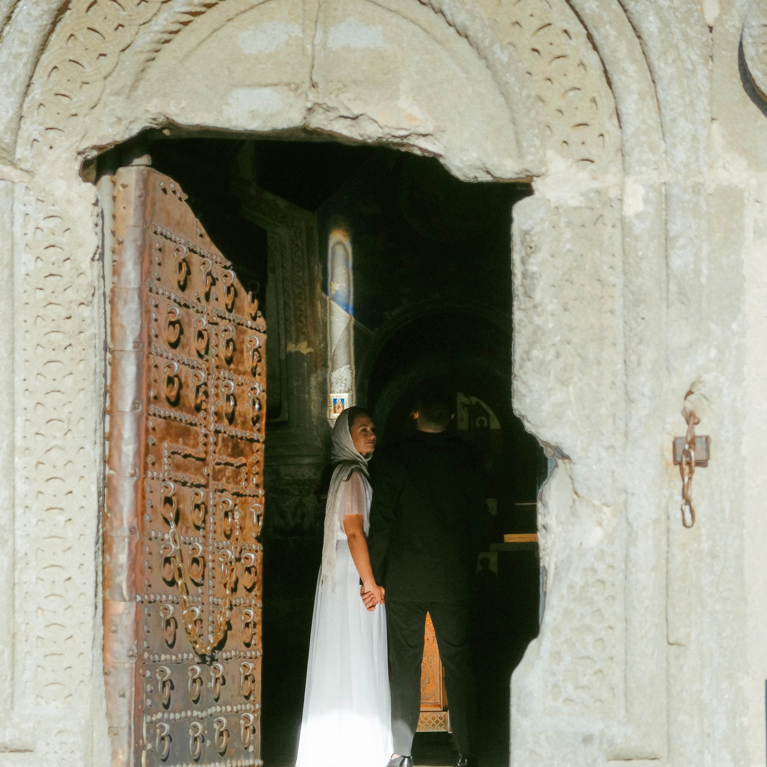 Bride and groom inside the Gergeti Trinity Church in Kazbegi, Georgia
