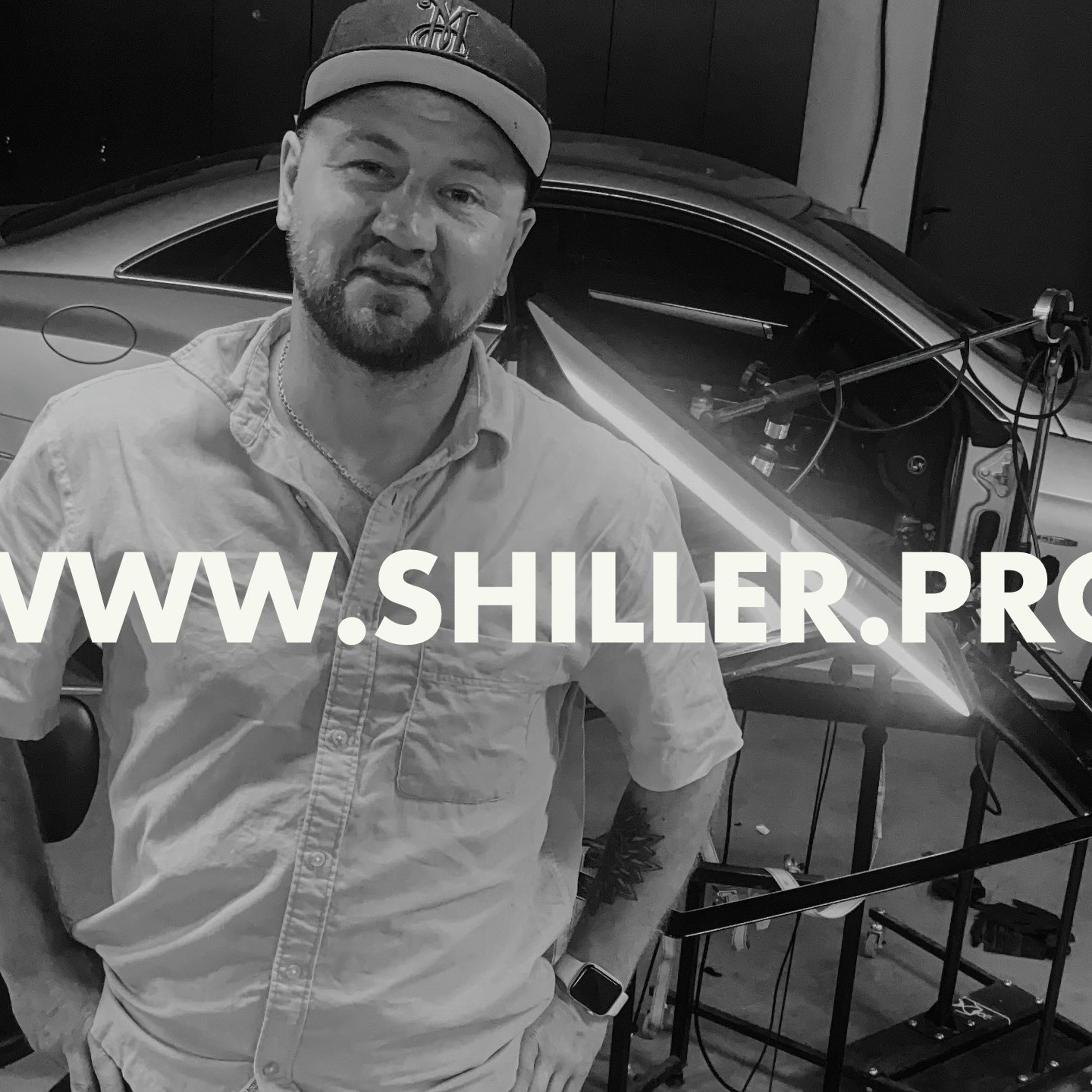 Улыбающийся мастер детейлинга с готовым автомобилем после завершения работ Финальная проверка работы мастера детейлинга: оценка качества выполненных услуг"