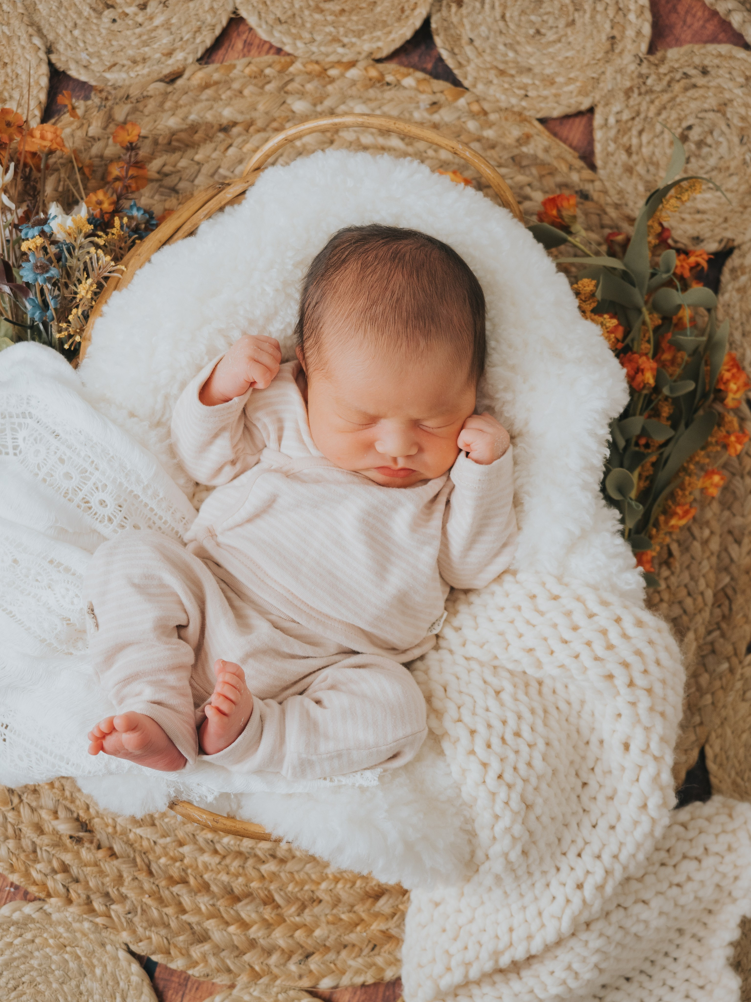 Sleeping newborn in basket.