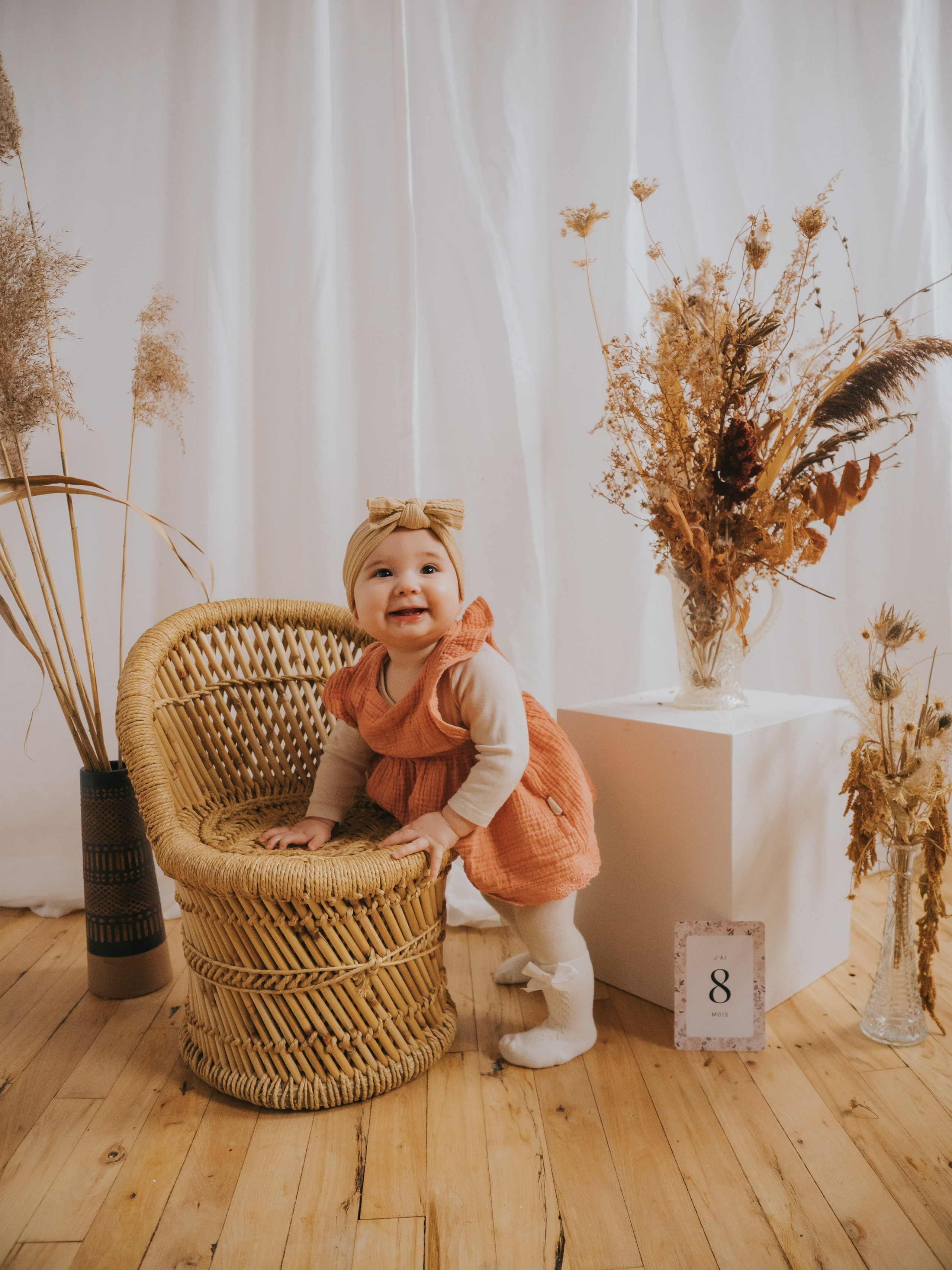 Little girl in studio for her milestone session with a boho setup in Montreal.