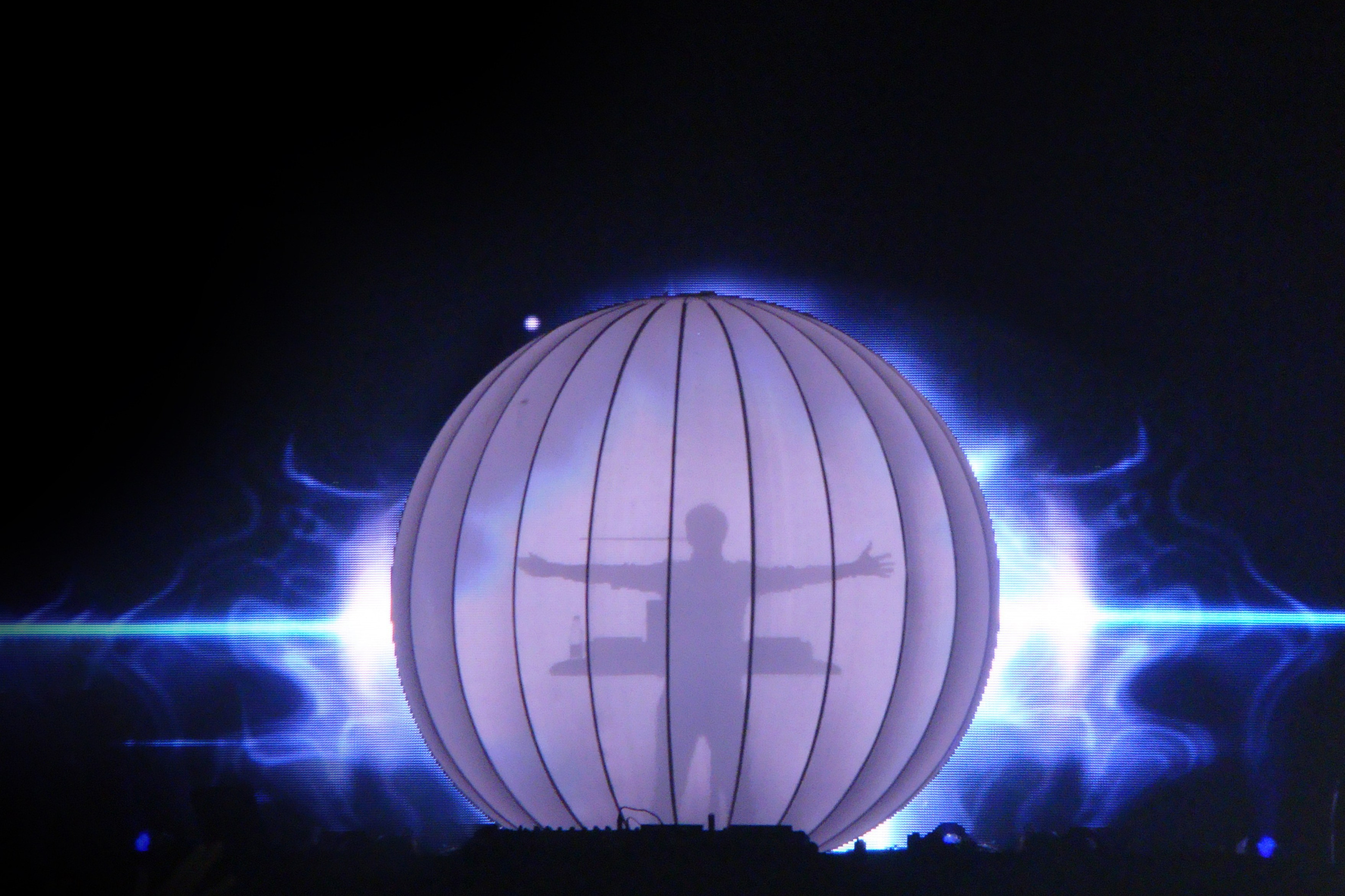 Dramatic DJ entrance at a music festival, with lights and energy building up the anticipation