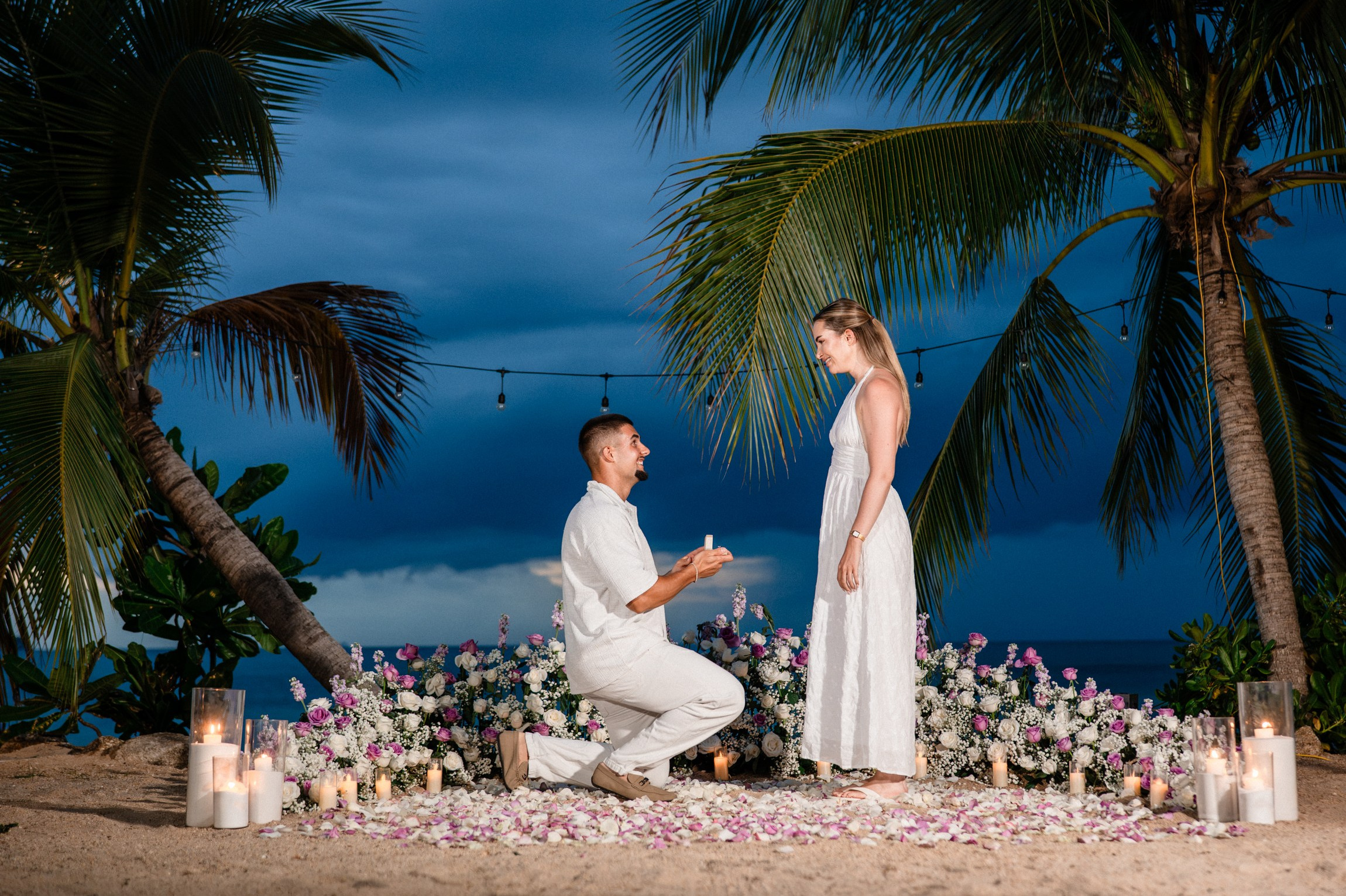 Romantic dinner and proposal setup on Koh Samui beach for couples celebrating engagement.
