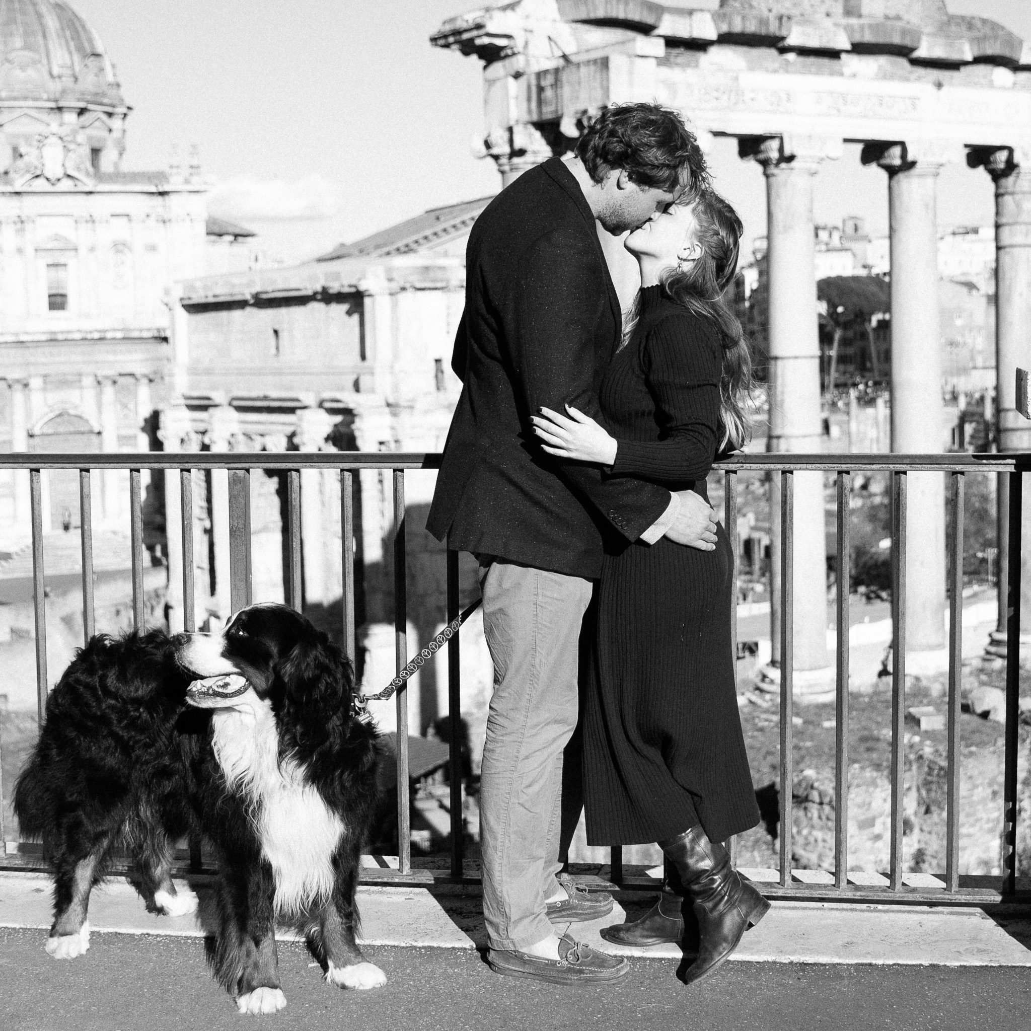 A couple embracing with the Foro Romano as their backdrop.
