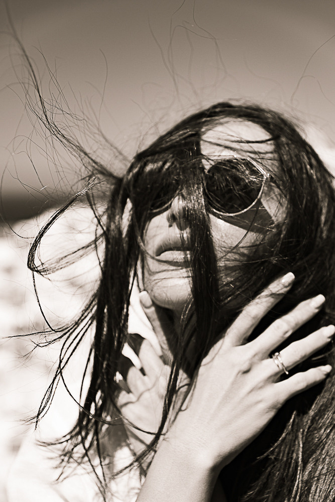 Portrait of a girl in windy weather in Santorini