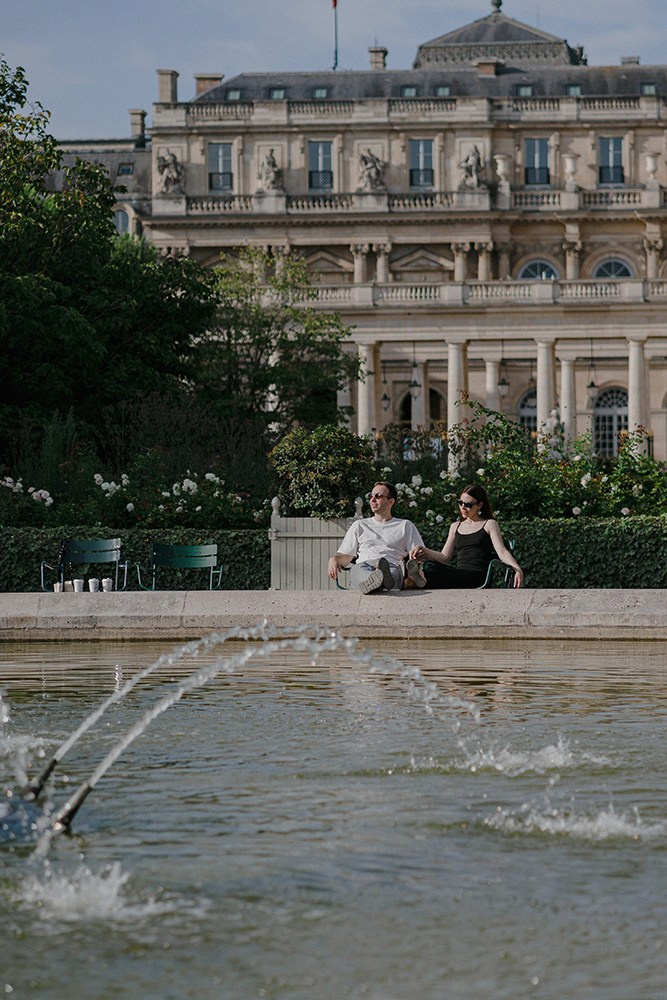 Arcades and fountain at Palais-Royal with blooming flowers