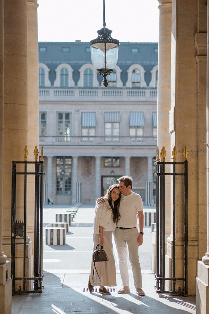 A couple in the arcades at Palais-Royal during a photoshoot