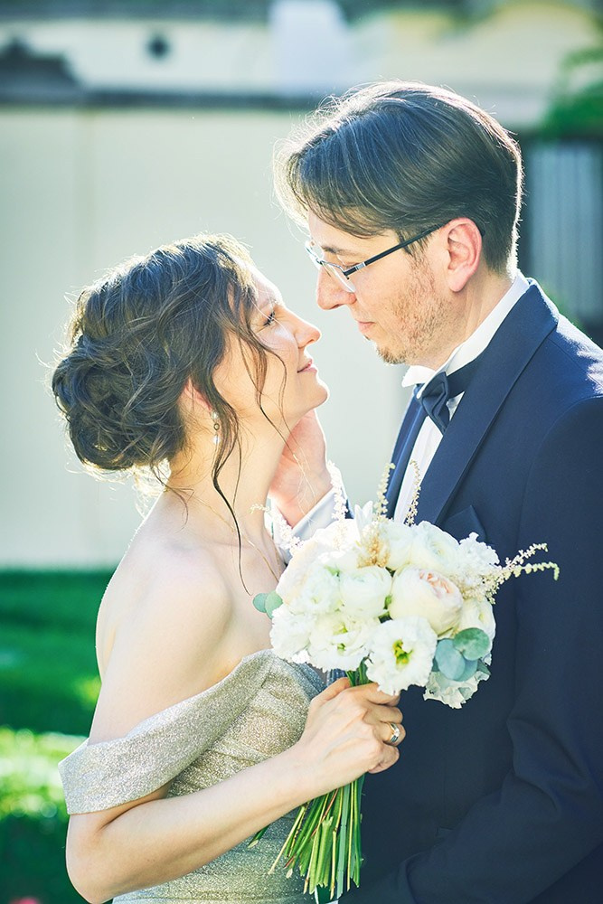 Ina and Vladimir embracing in the summer sunlight at the Vrtba Garden