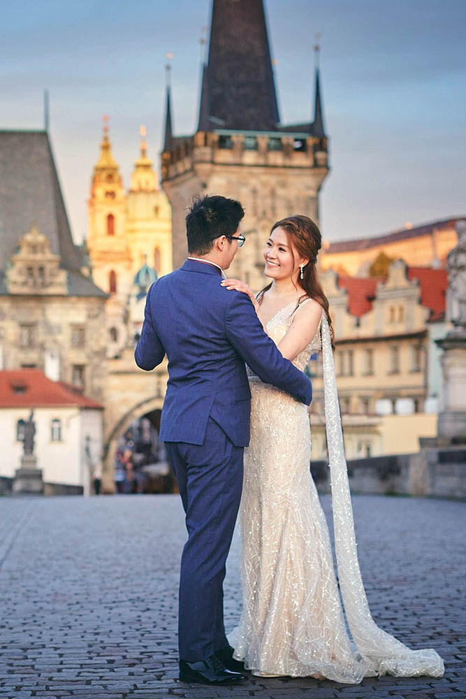 A couple dances alone on an empty Charles Bridge shortly after sunrise.