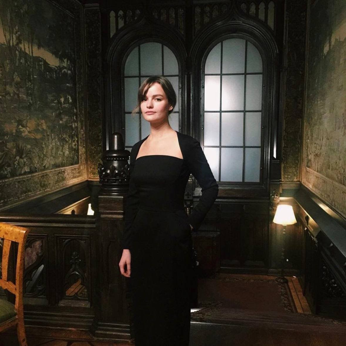 Portrait of wedding photographer Inna Zaytseva in an elegant historic interior, reflecting her timeless and artistic photography style