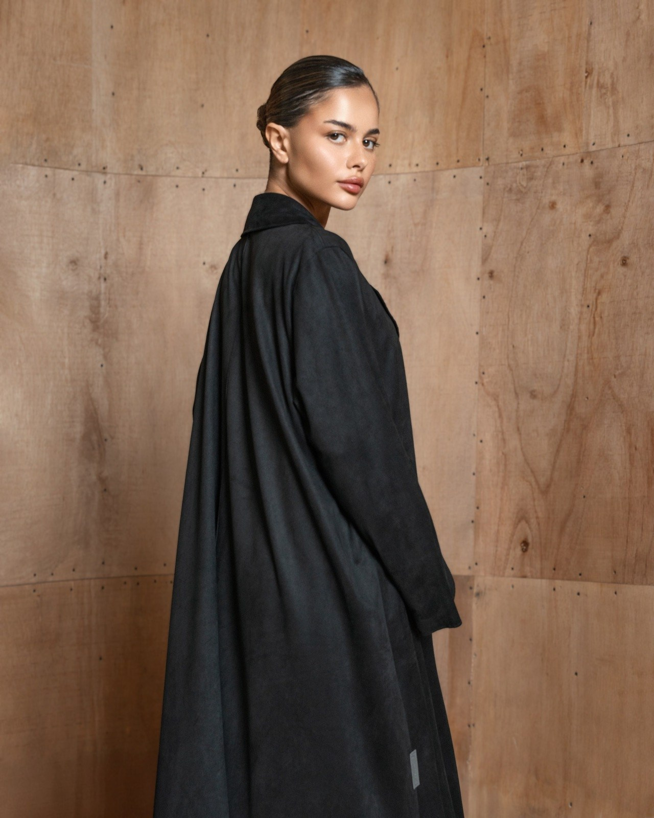 Model wearing a black abaya for a professionally planned fashion collection shoot