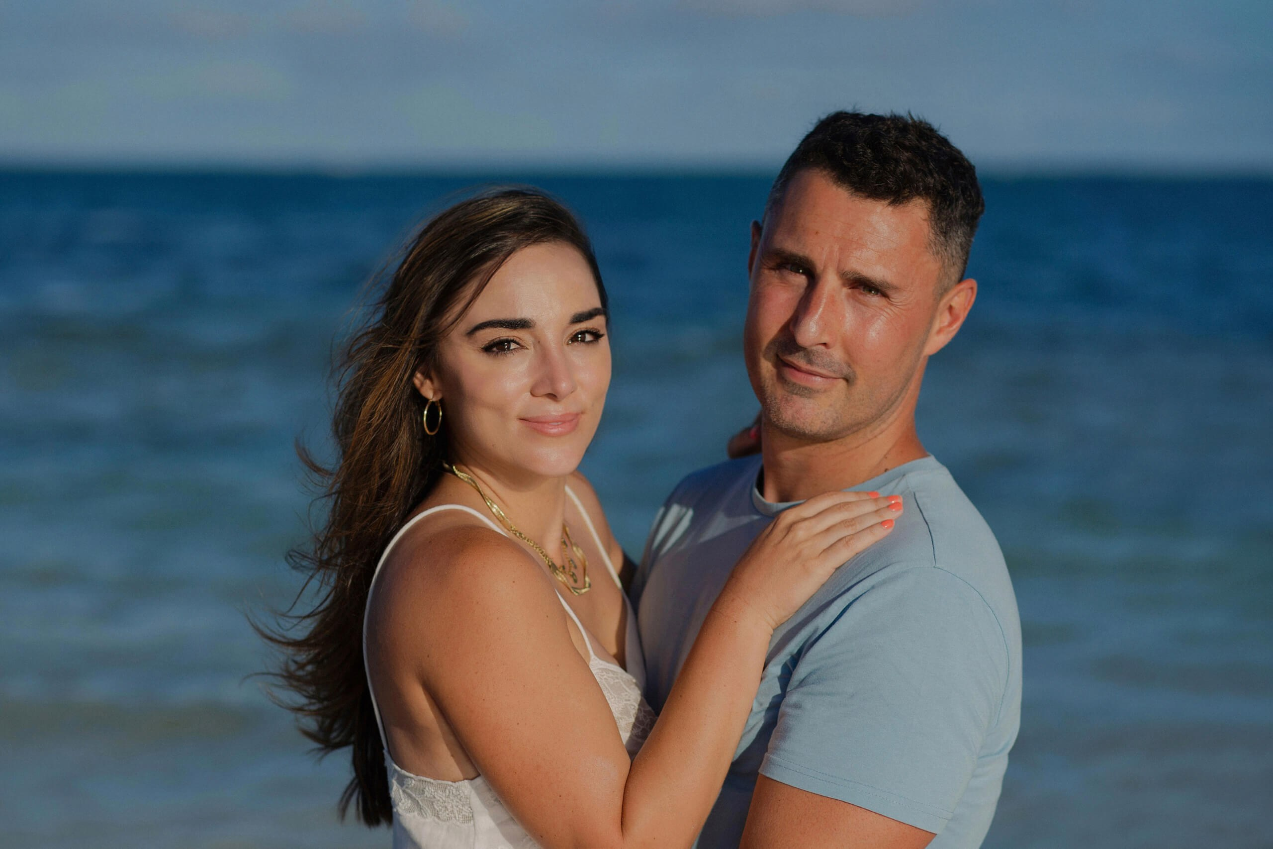 Kenya wedding photography on beach, couple smiling at oceanfront.