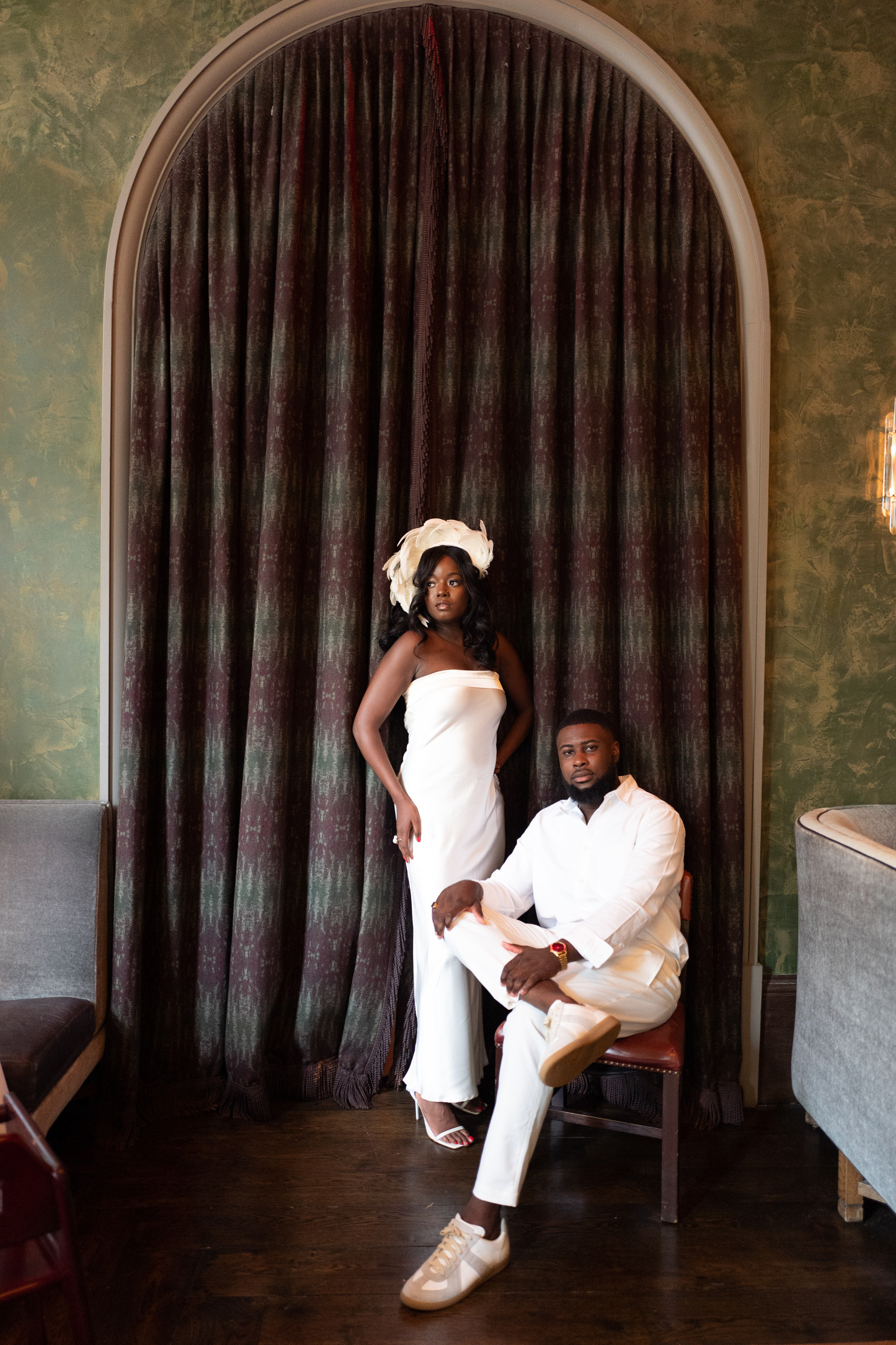 a man and woman sitting on a chair in a room