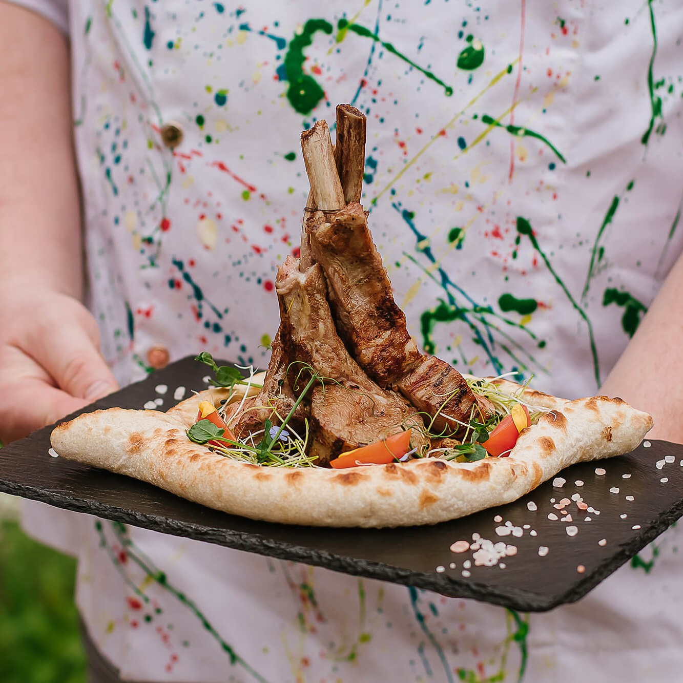 Premium wine photography in Melbourne, featuring a glass of red wine at a scenic vineyard setting.