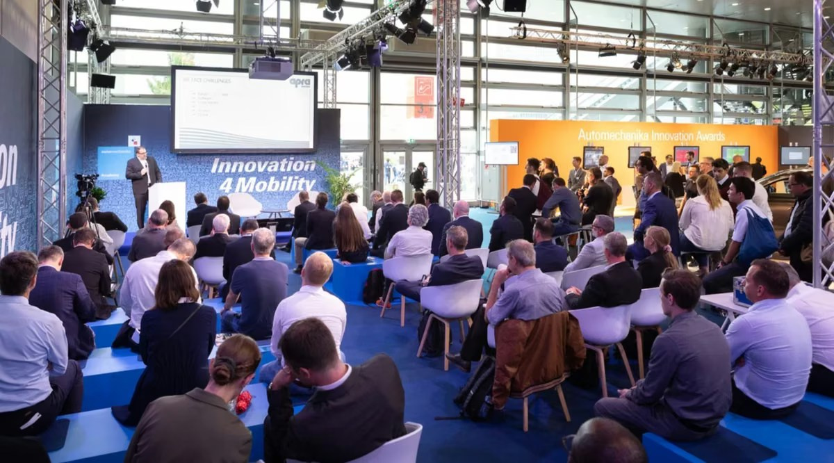 Wide view of a keynote speaker and audience during a professional corporate conference