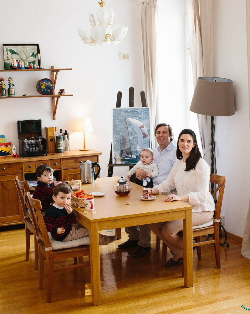 Family with two kids sitting at the table in French style apartment in Munich 