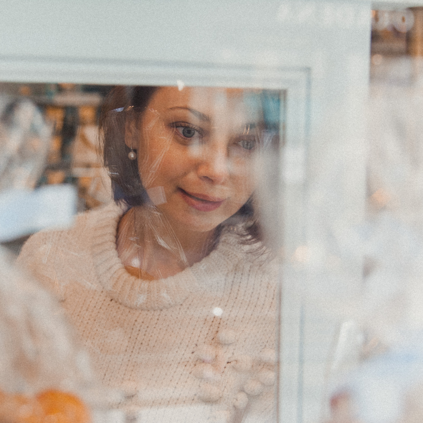 A confident woman striking a natural pose with soft lighting and a relaxed expression.