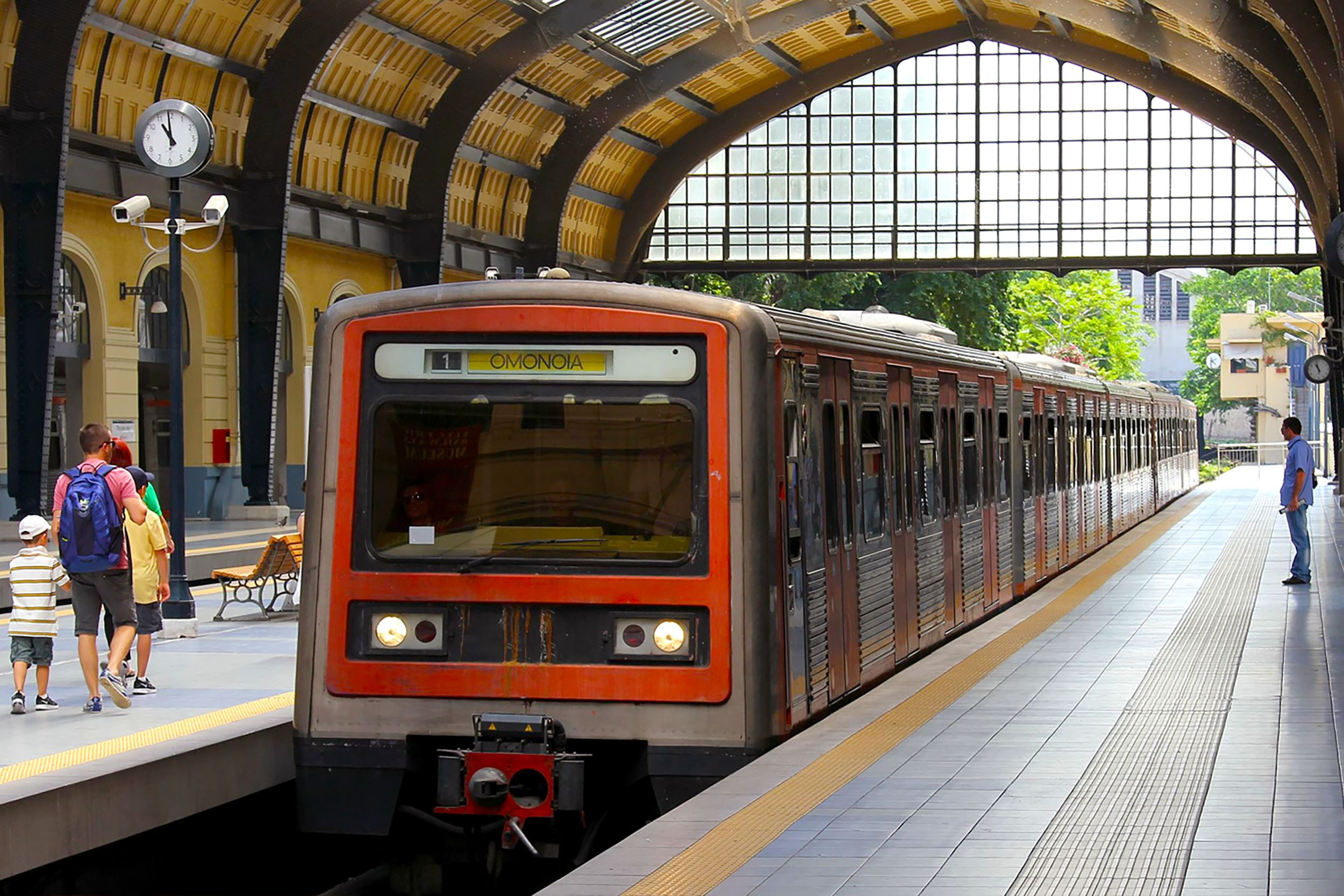Athens Metro train at Piraeus Station platform, illustrating subway travel for port and city center connections