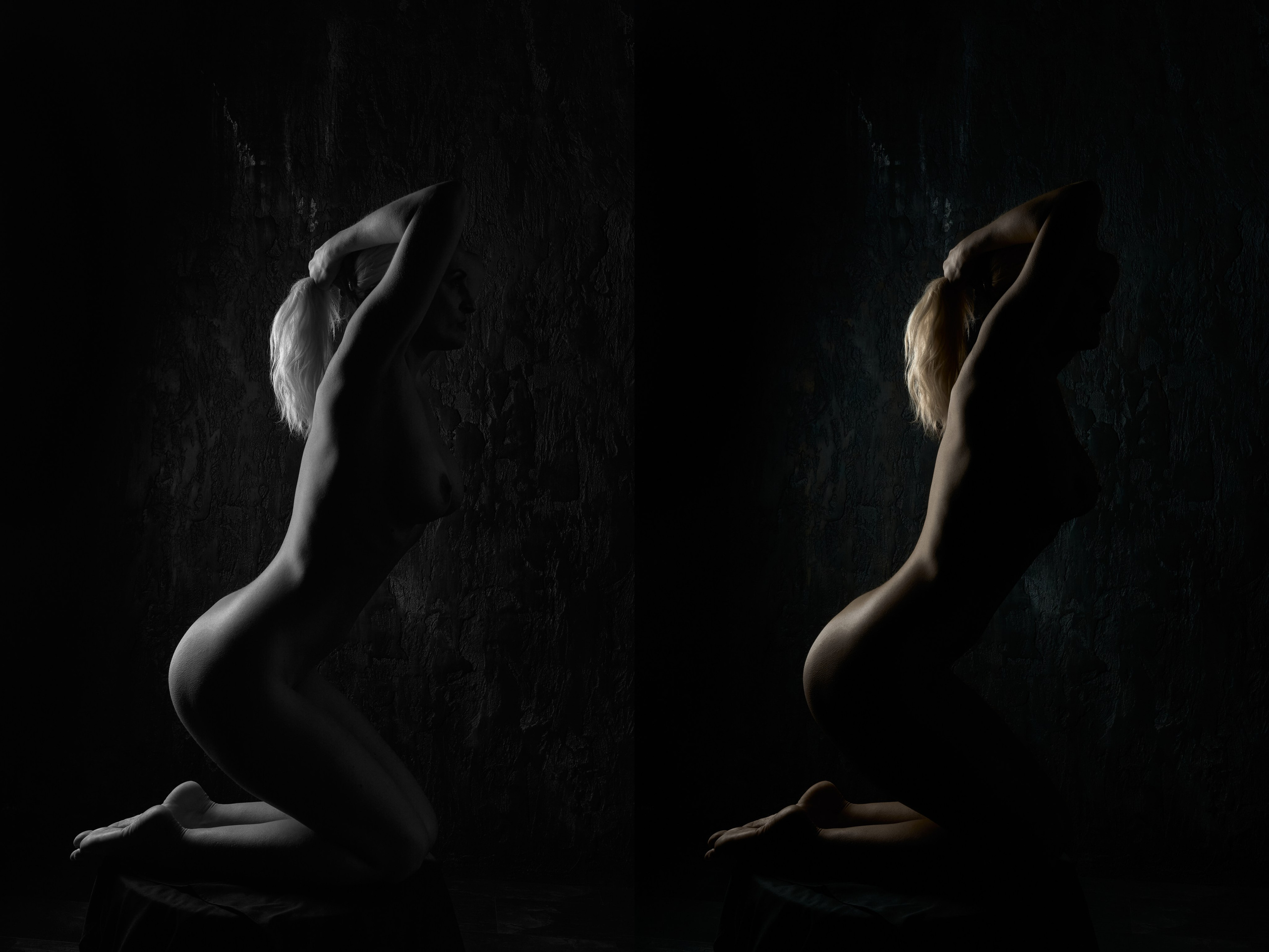 Arched nude figure against dark wall, chiaroscuro fine art composition