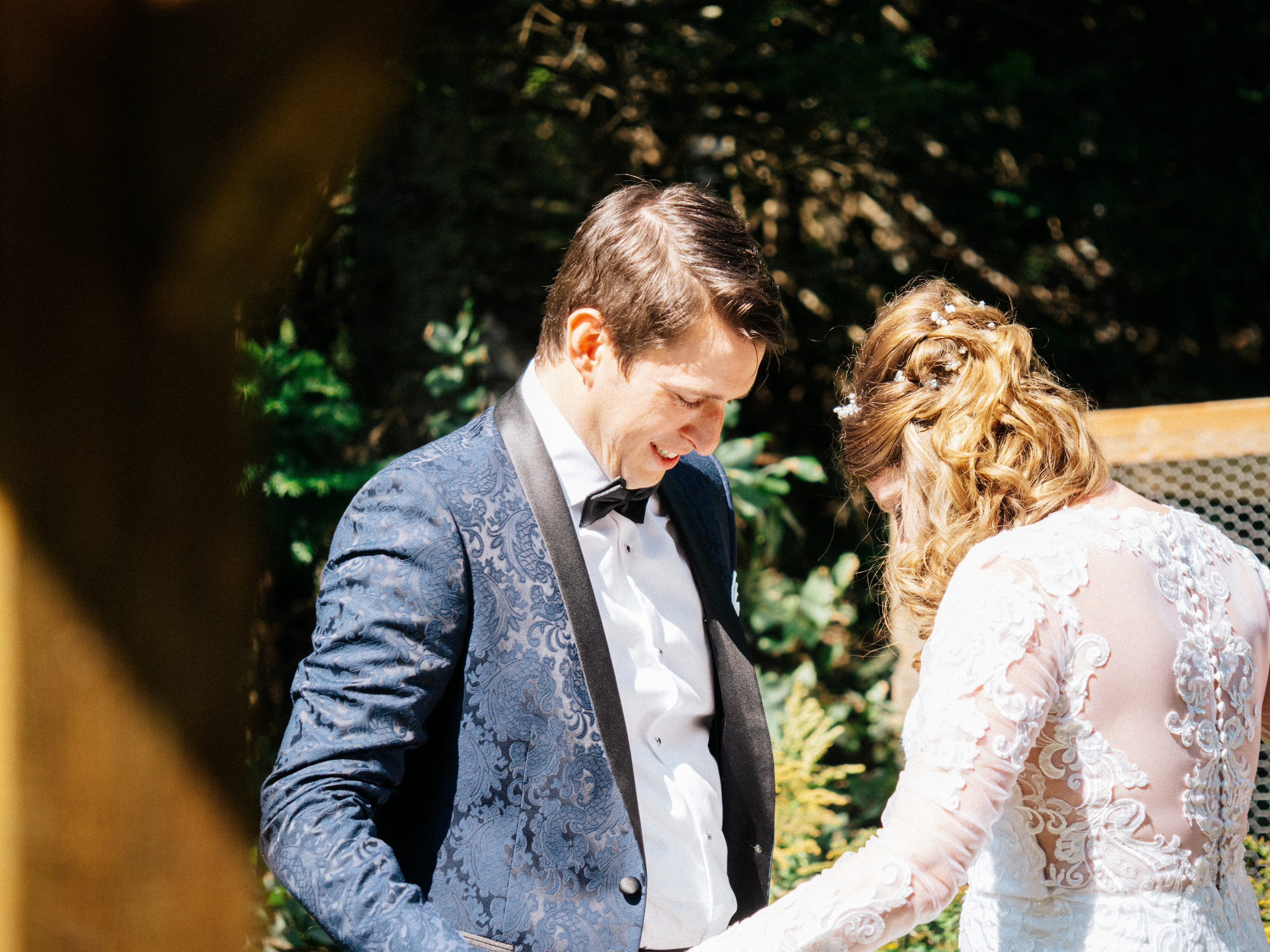 The groom looks at the bride after seeing her for the first time on their wedding day.