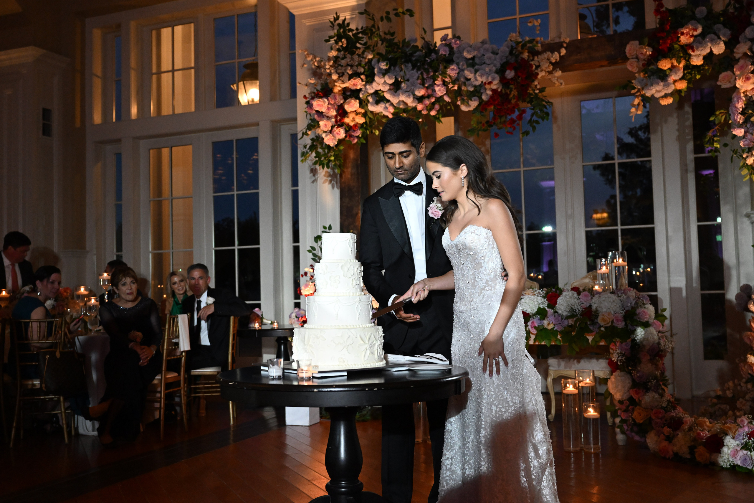a bride and groom cutting their wedding cake