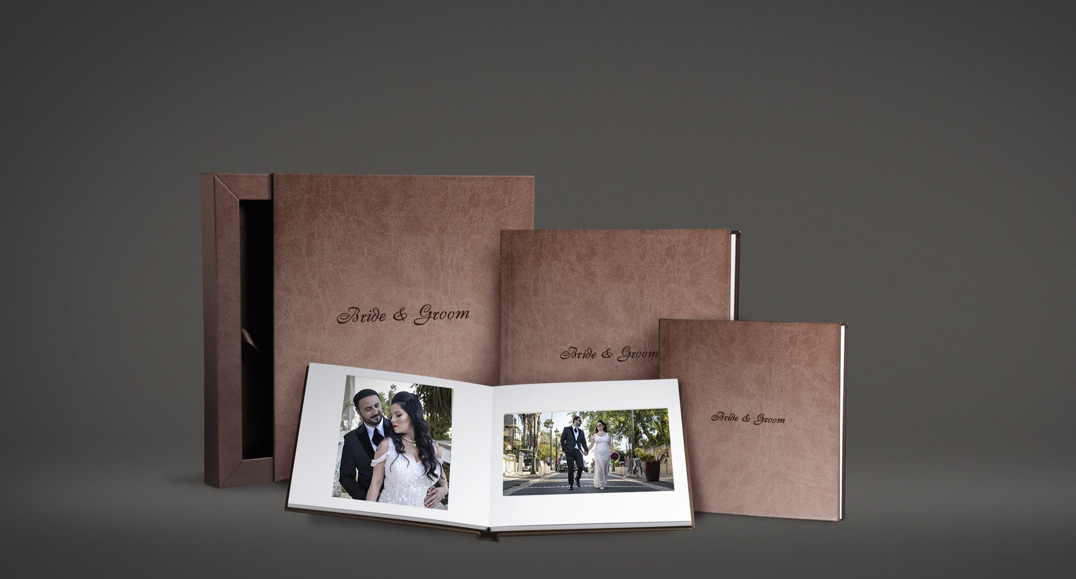 A wedding album collection with an open album, matching parent albums and a presentation box